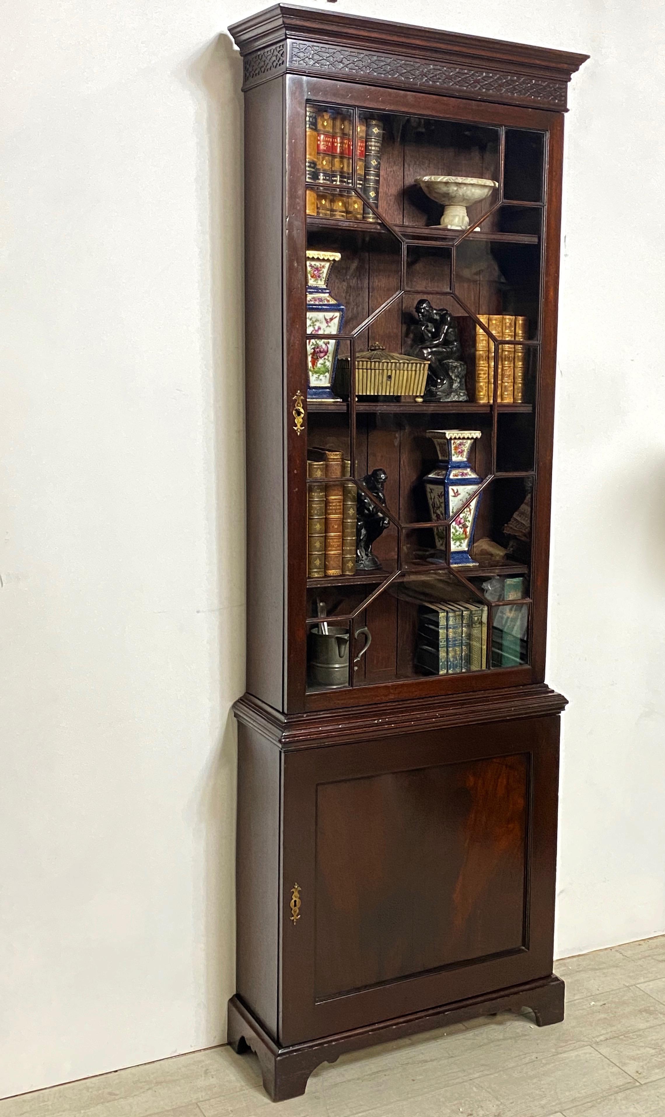 An unusually slender George III period mahogany bookcase / cabinet. Paned glass top section over a lower cabinet with a single shelf. 
In excellent original condition with original finish. 
Easy to use size in just about any room.
England, 1st