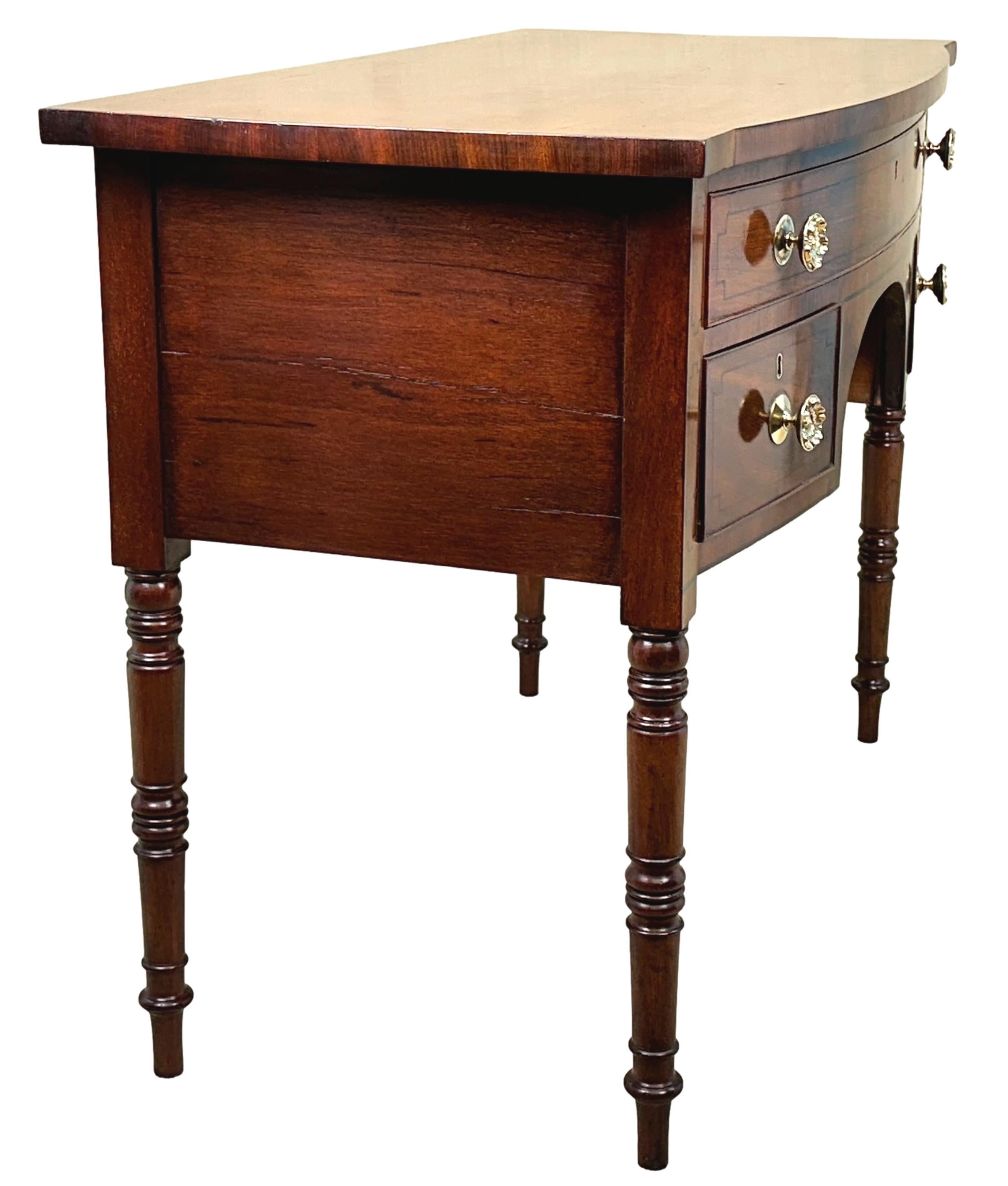 A Good Quality, Late 18th Century, George III Period Mahogany Bowfronted Dressing Table, Of Good Rich Colour Throughout, Having Well Figured Top, Over One Long And Two Short Drawers With Replacement Brass Knobs To Elegant Arched Frieze With Ebonised