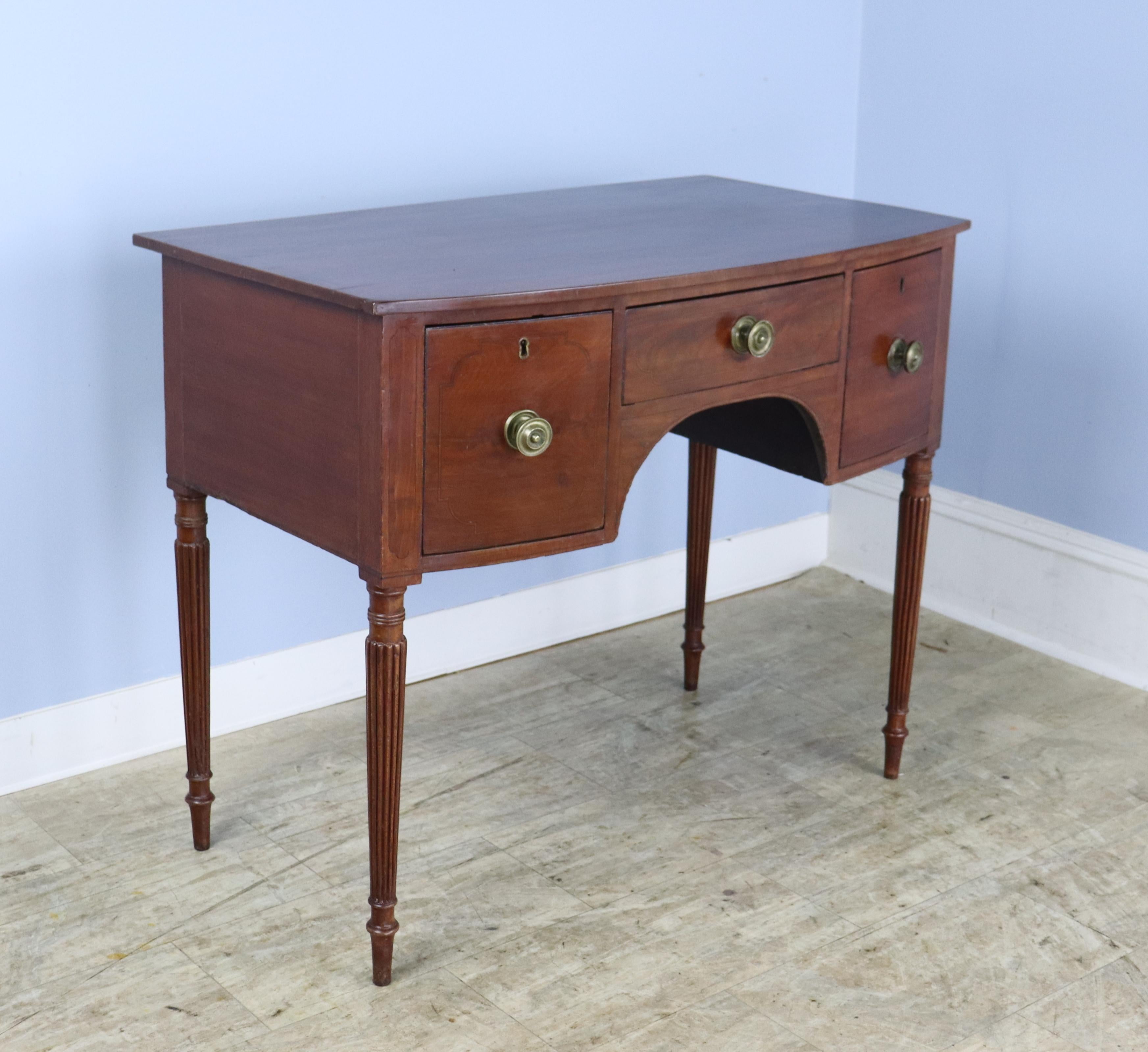 An 18th Century Georgian mahogany side table, hall table or serving table with ebony stringing along the top and drawers.  The piece is in good antique condition with a small mark on the top, shown, and some fine wear at the edges - to be expected