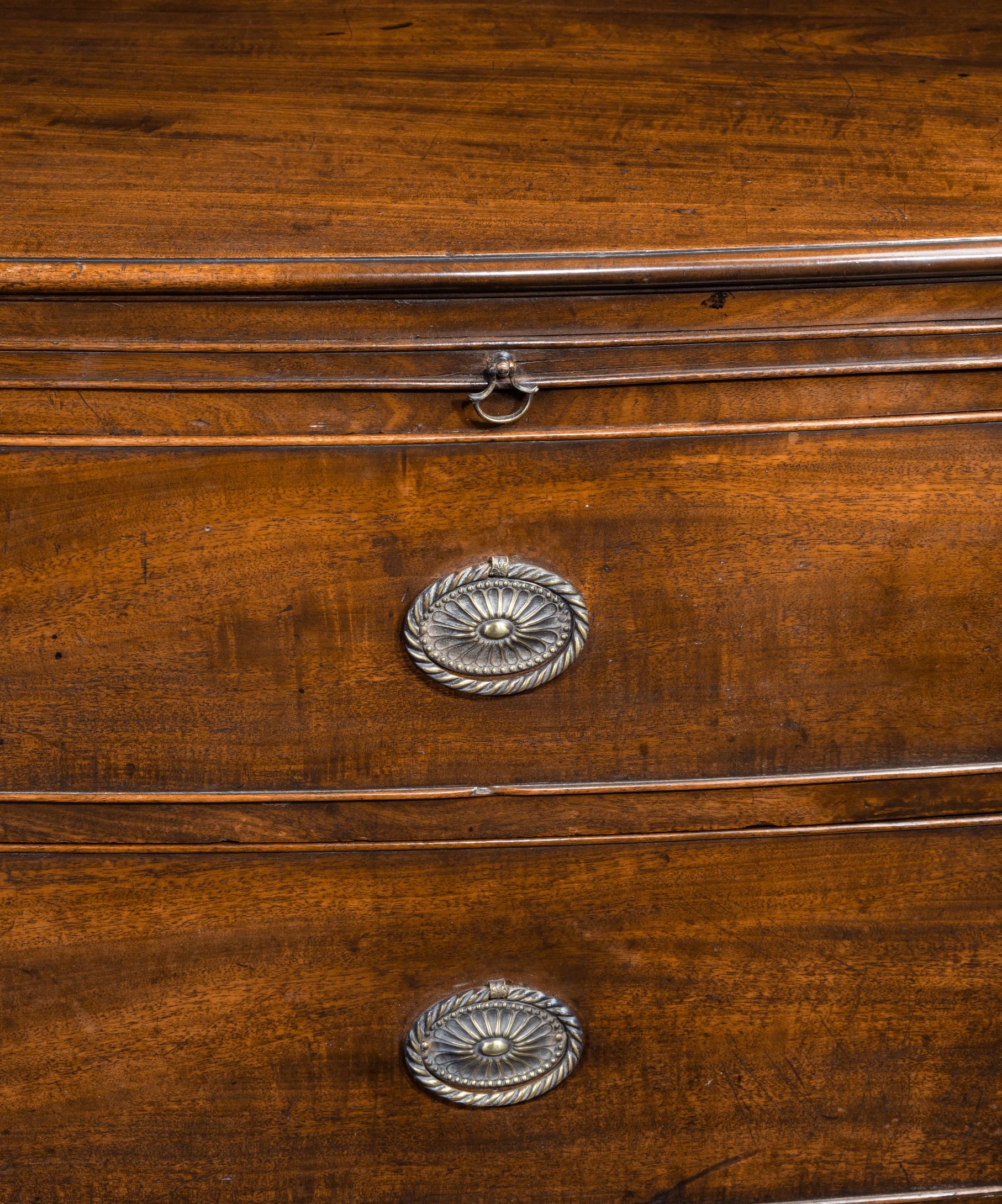 A Georgian mahogany bow front chest of drawers, the beautifully figured top above a brushing slide and three graduated drawers; raised on elegantly swept bracket feet.

This chest of drawers has beautifully elegant proportions and is veneered