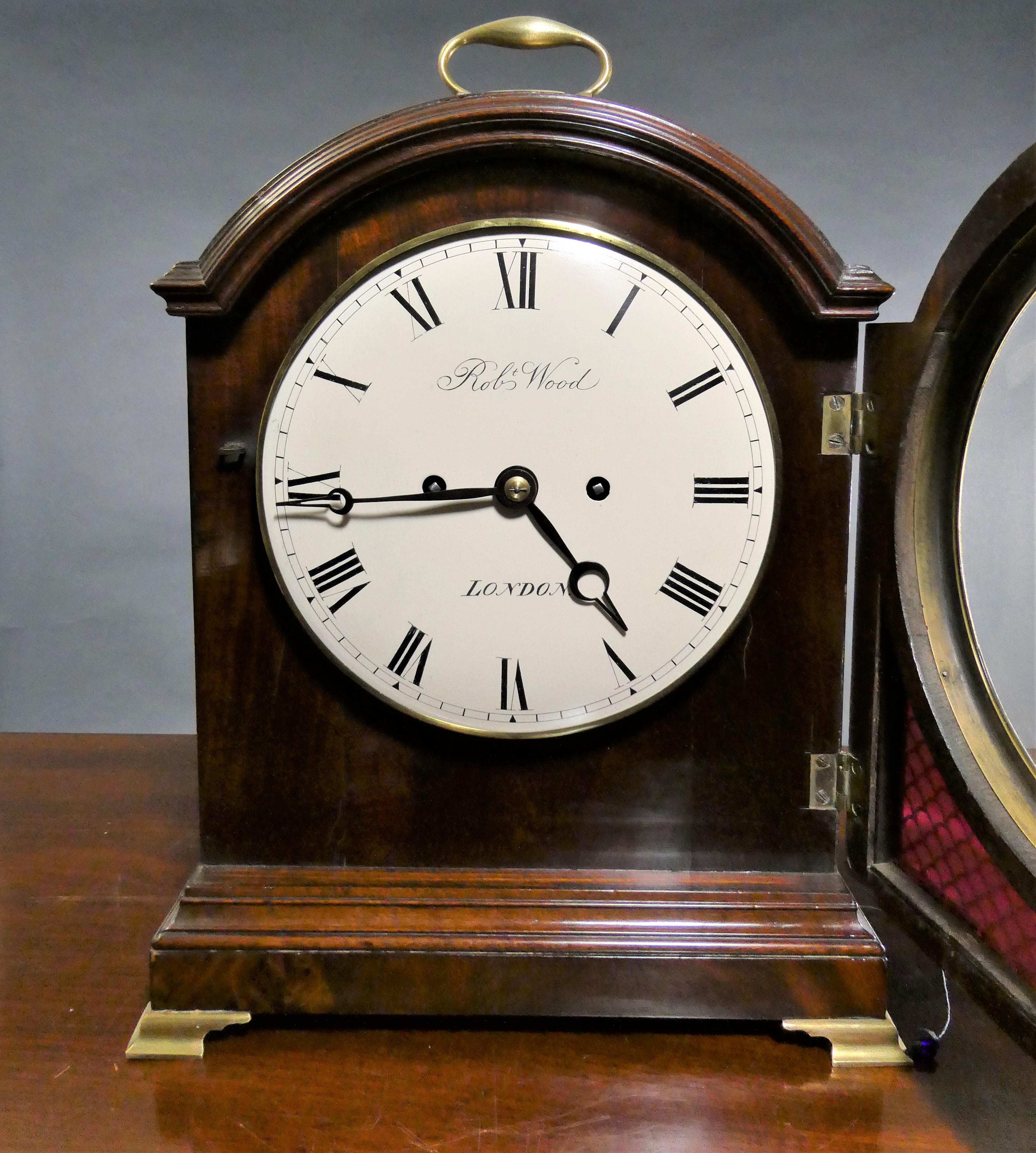 Georgian mahogany bracket clock

Finely figured flame mahogany break arch case inset at the front and sides with fishscale silk lined sound frets standing on a raised plinth and resting on brass bracket feet. The arch with brass bound single pad