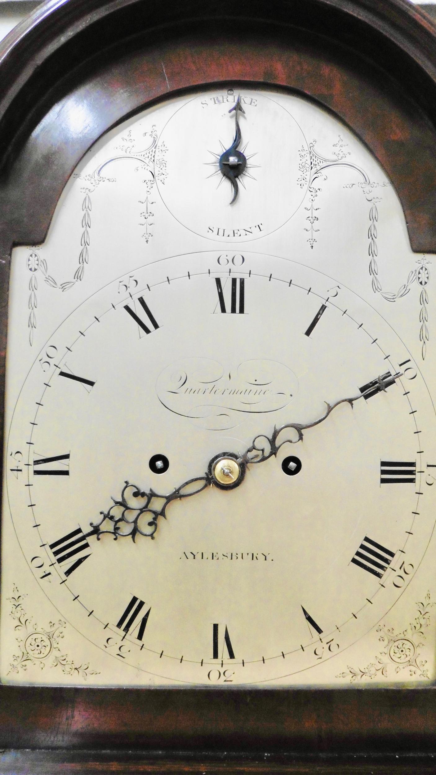 Georgian bracket clock by Joseph Quartermaine, Aylesbury.

Mahogany brass bound case standing on a raised stepped plinth and resting on brass bracket feet with red silk lined fish scale sound frets to both sides surmounted by a break arch with