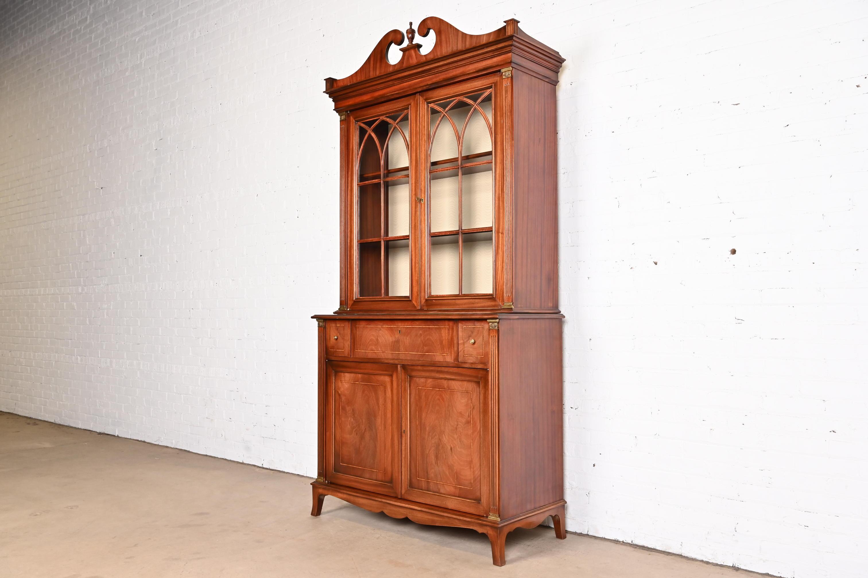 A beautiful Georgian or Chippendale style breakfront bookcase cabinet with drop front secretary desk

From the Armando Collection

Italy, Late 20th Century

Gorgeous carved mahogany, with original brass hardware and accents, mullioned glass