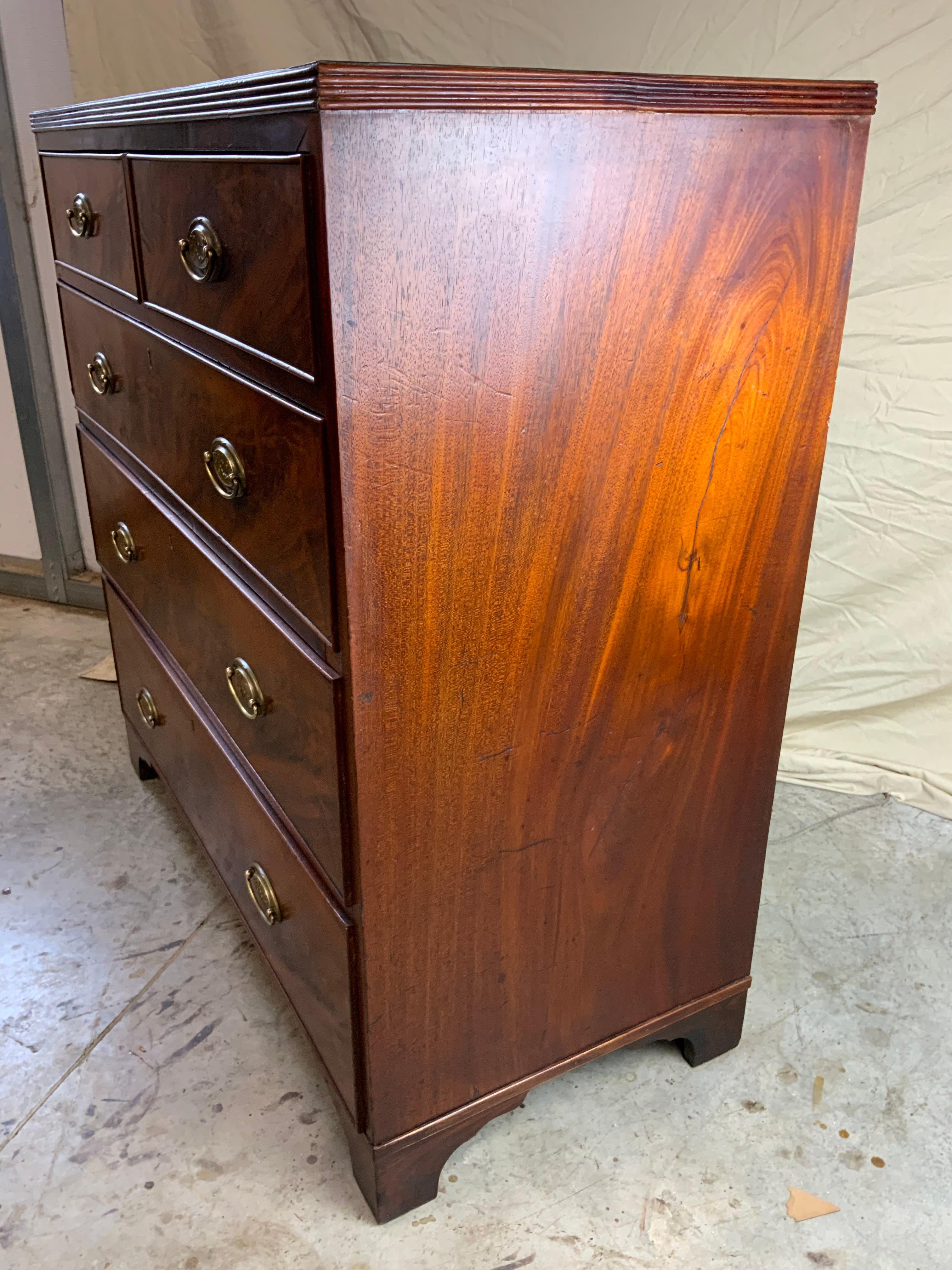 A very nice Georgian two over three drawer Mahogany chest.  The top reeded edge with book matched and cross banded veneer.   Pine secondary wood on the dovetailed case with decorative crotch Mahogany drawer fronts.  Old refinished surface in very