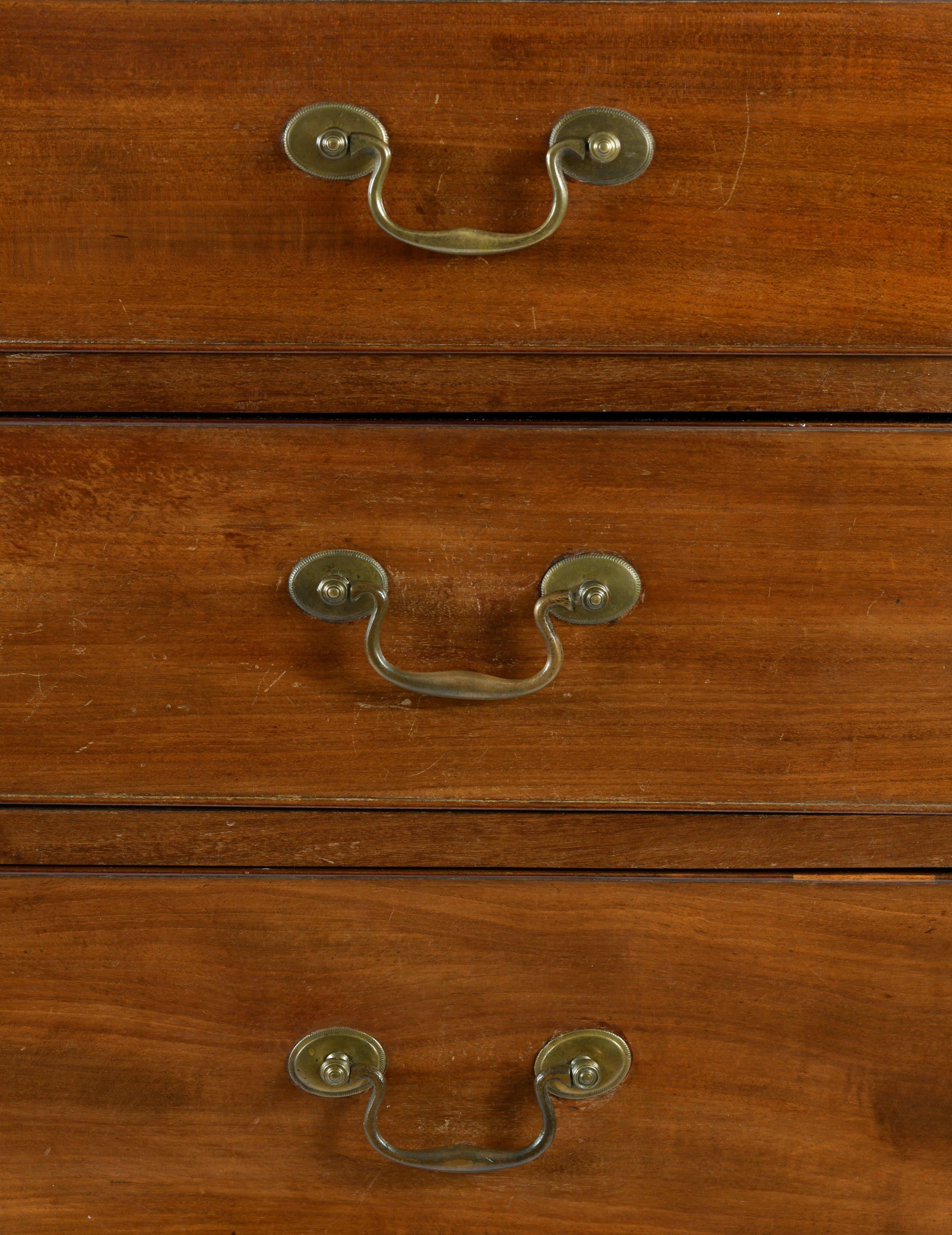 This very handsome and simplistically styled mahogany chest of drawers features 5 long graduating cock beaded drawers with the original brass handles and hardware. The chest measures 37 ½ in – 95 cm wide, 21 in – 53.3 cm deep and 44 ½ in – 113 cm in