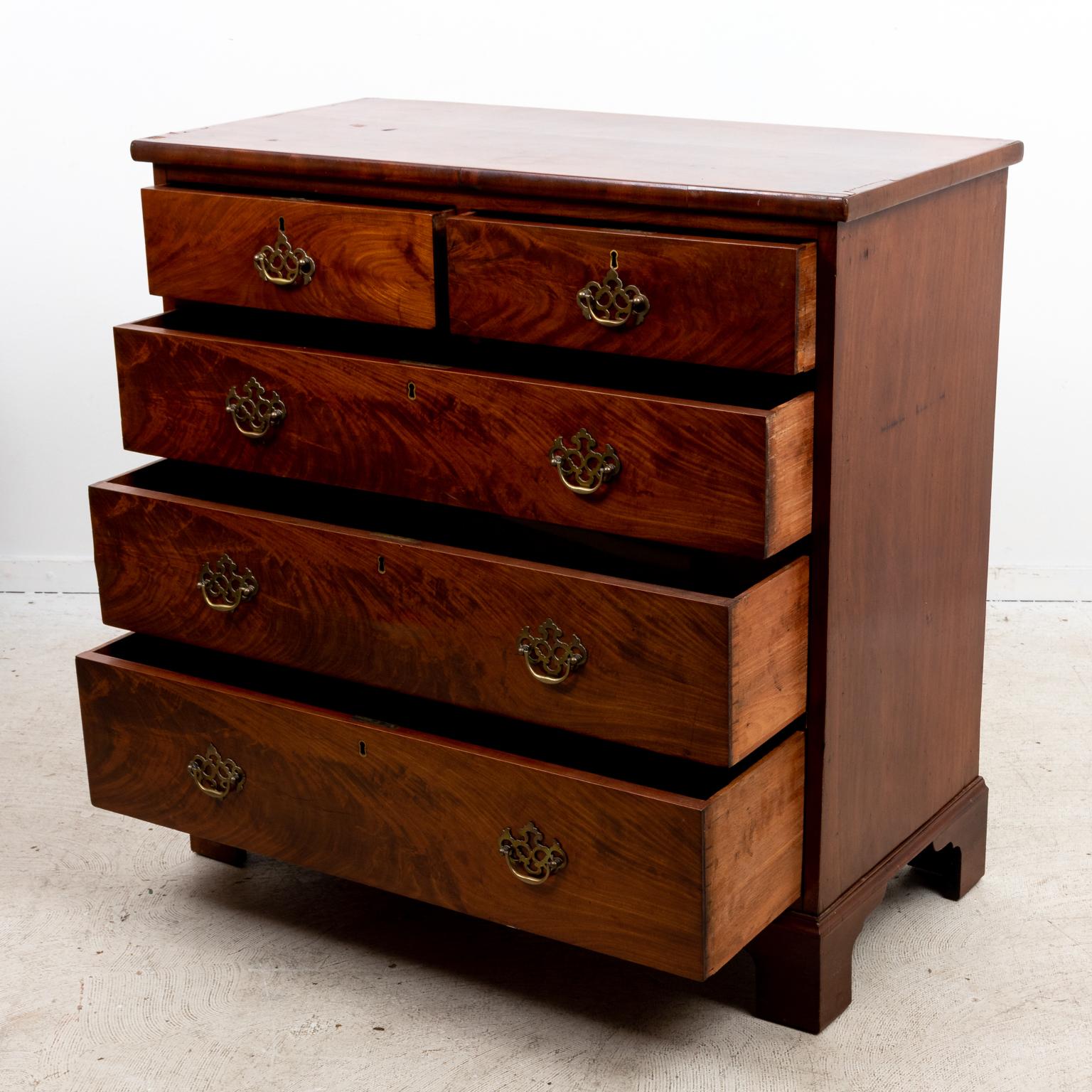 Circa mid-19th century Georgian mahogany chest of drawers with bat's wing escutcheon on ogee bracket feet. The piece comes with two small drawers over three larger drawers. Please note of wear consistent with age and fair condition including finish