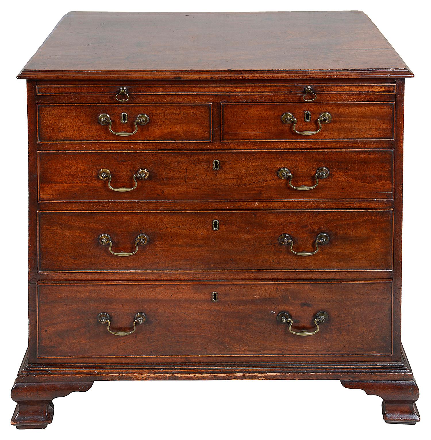 A very good quality late 18th century Georgian mahogany chest of drawers, having a brushing slide, original brass handles, five graduating oak lined drawers and raised on carved Ogee bracket feet.