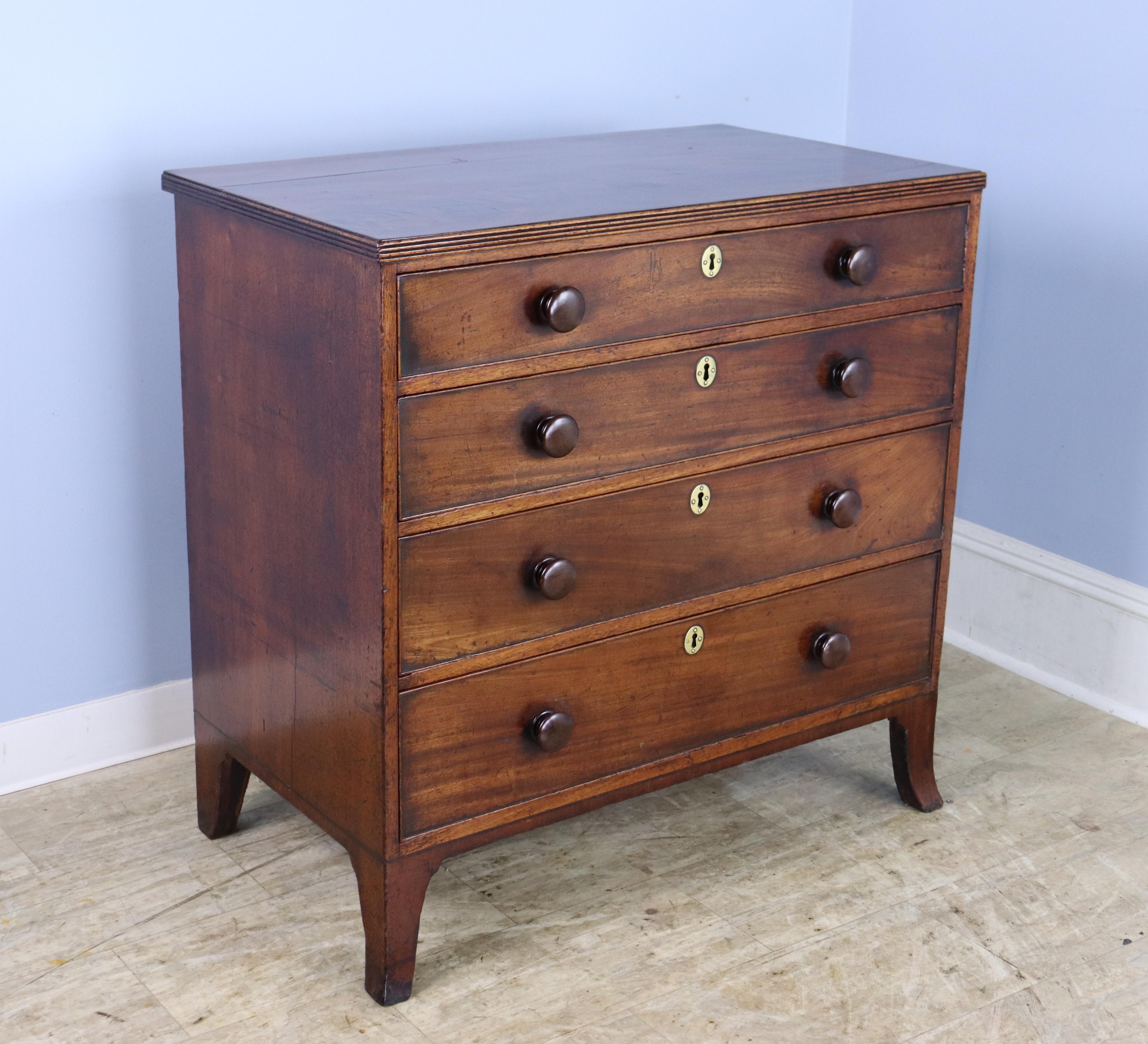 An elegant mahogany bureau in very good antique condition. The mahogany is a rich medium color with a lovely grain. Details of note include the decorative  reeded edge on the top, discreet cockbeading on the drawers, and beautifully wrought brass