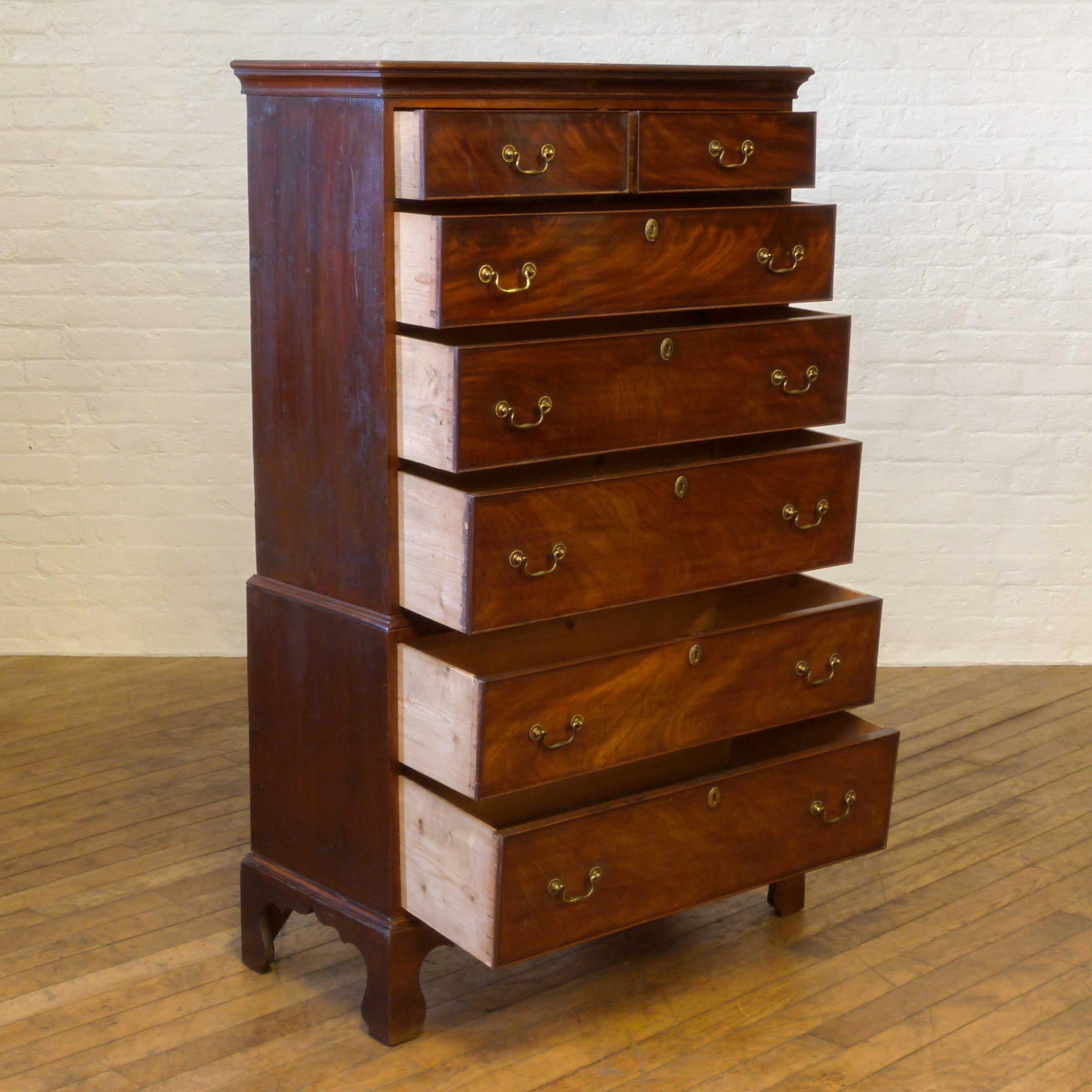 A small and attractive two stage Georgian mahogany chest on chest circa 1800 and possibly of Welsh origins with its stained pine sides. The drawer fronts are nicely figured and still retain their original handles and escutcheons. Nice and original