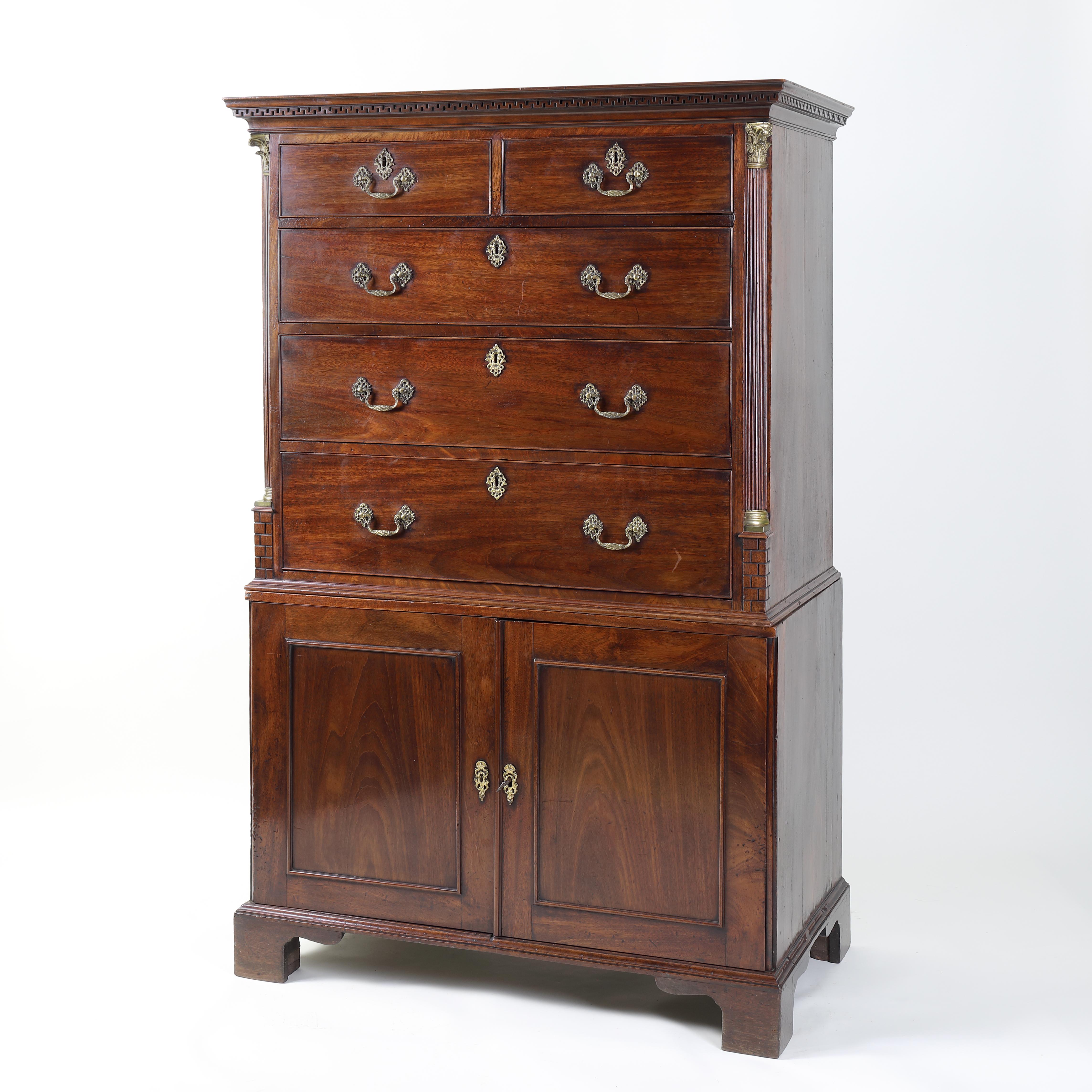 A rare and unusual small 18th century mahogany tallboy consisting of a chest of drawers above a two door linen press/cupboard. The top with dentil cornice above an arrangement of two short and three long graduated drawers flanked by quartered fluted