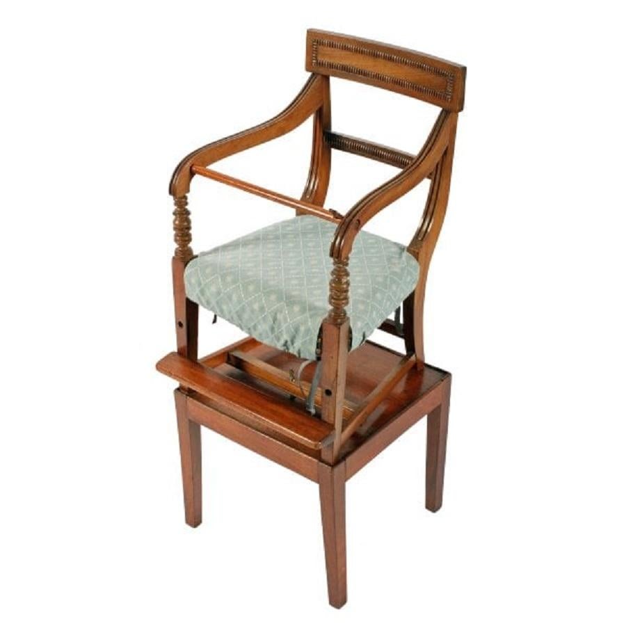 An early 19th century Georgian mahogany child's high chair.

The high chair is made in two parts, a miniature arm chair to the top and a stand/table below.

The chair and stand are held together by an original brass bolt.

The arm chair is a