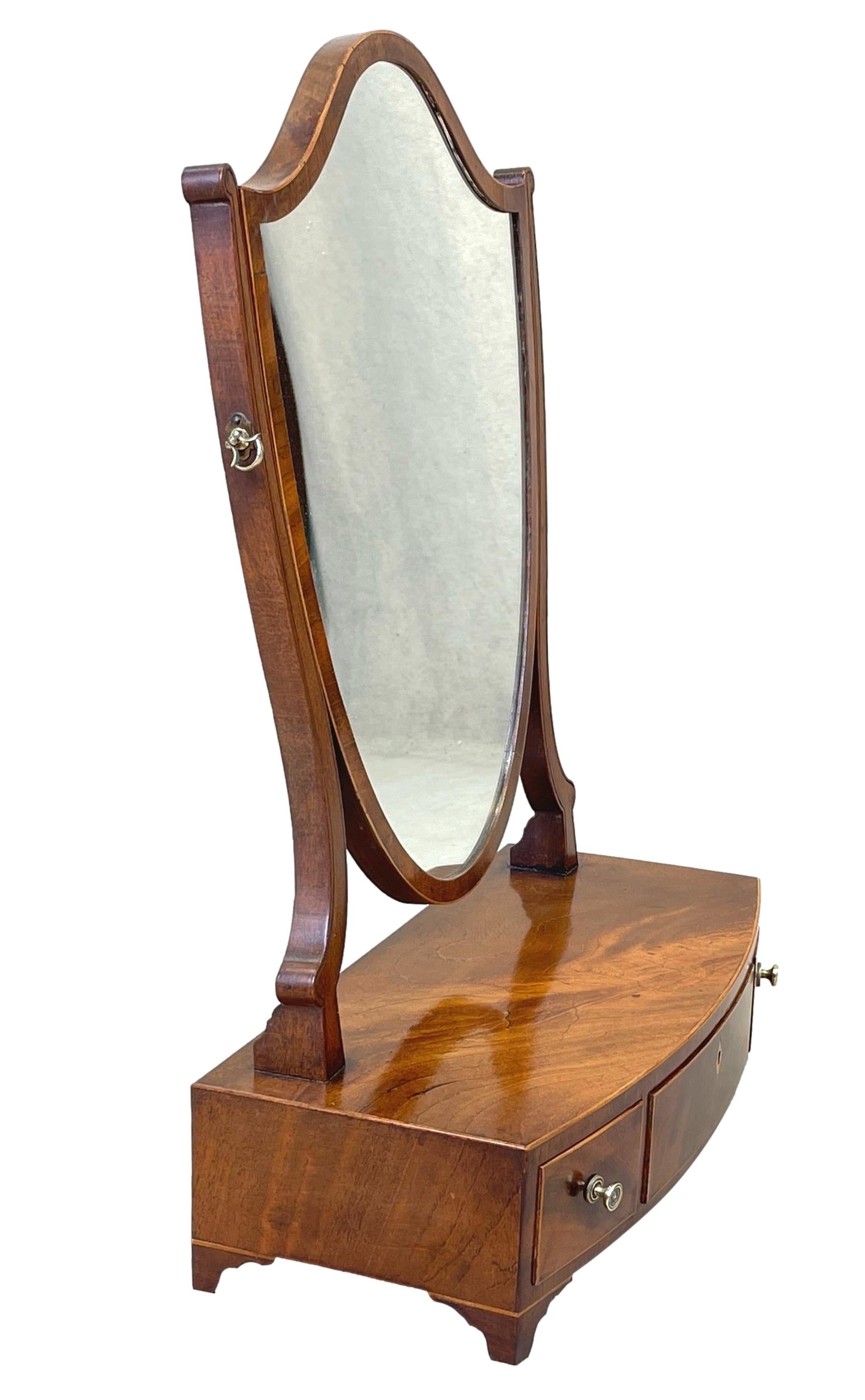 A Very Good Quality Late 18th Century Mahogany Georgian Dressing Table Mirror, With Elegant Shield Shaped Swing Plate, Over Well Figured Bowfronted Base With Three Drawers, Raised On Elegant Original Splayed Feet.


Dressing table mirrors, which can