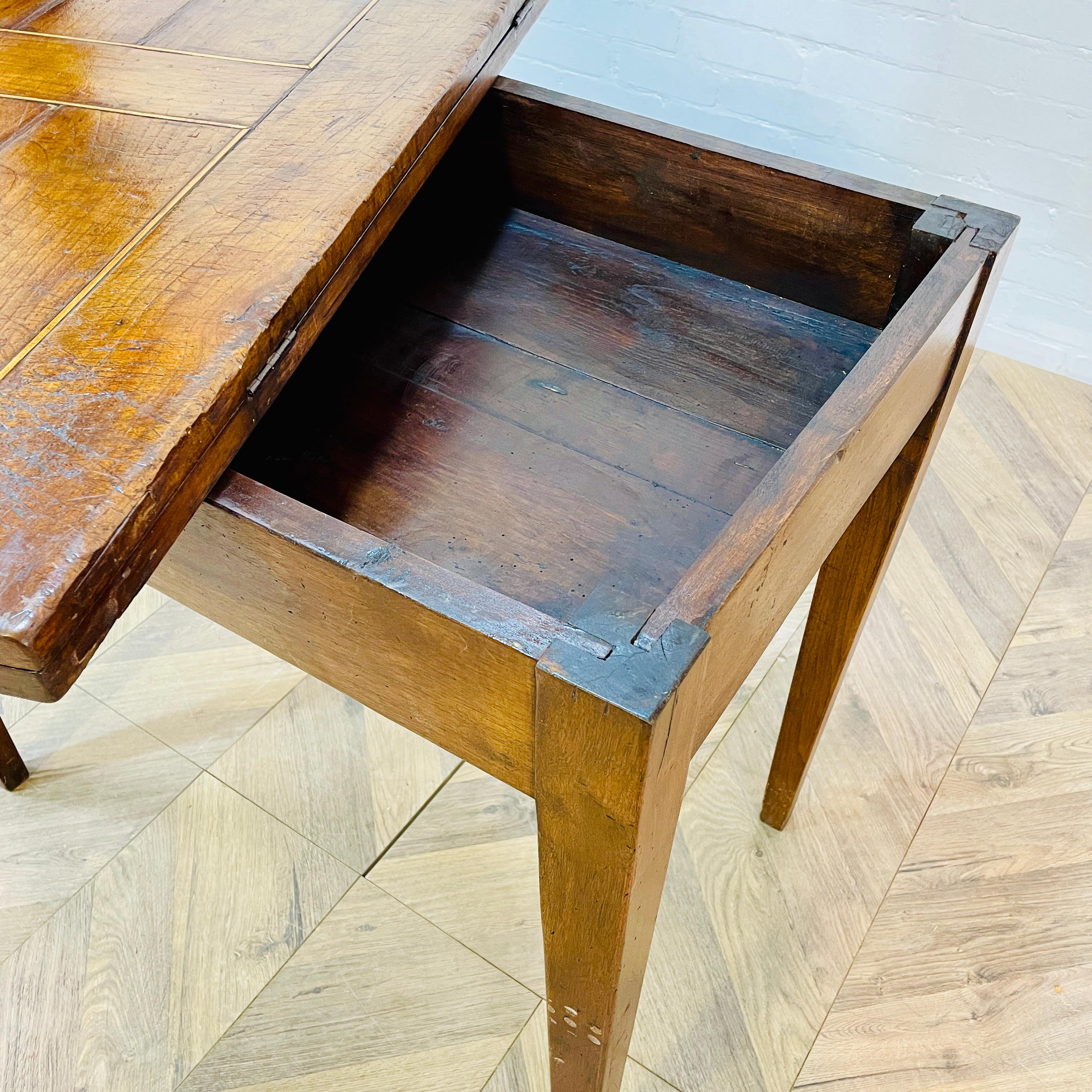 A Lovely English Antique Foldout Tea Table, Georgian Period circa 1790s.

The table, made from mahogany and structurally very strong, boasts additional storage underneath.

The table has a warm patina, but is showing wear to the table tops, but it 