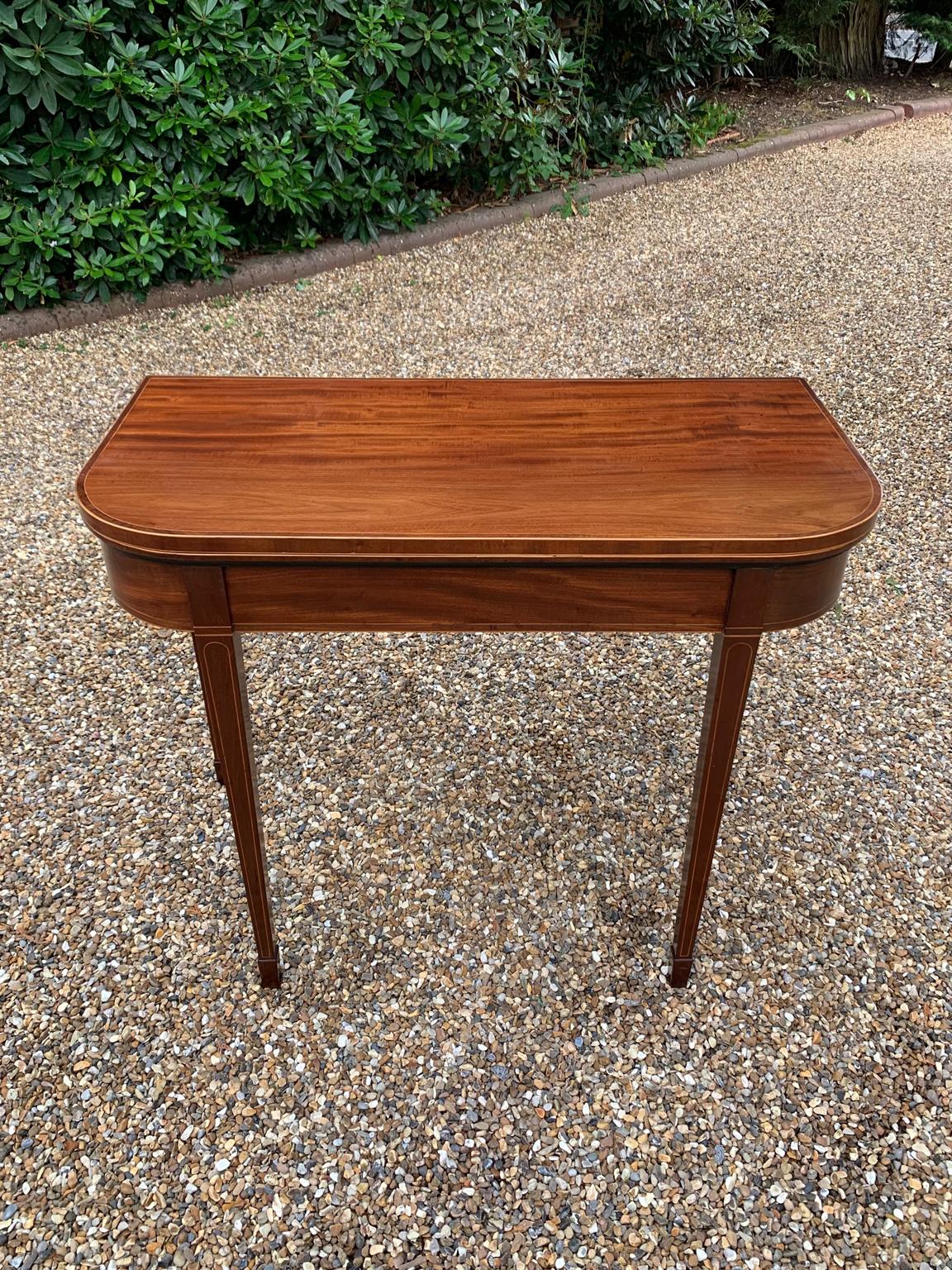 Georgian Mahogany Inlaid D-Shaped card table with inlay and banding, on square tapering legs and spade feet with a green baize inside.