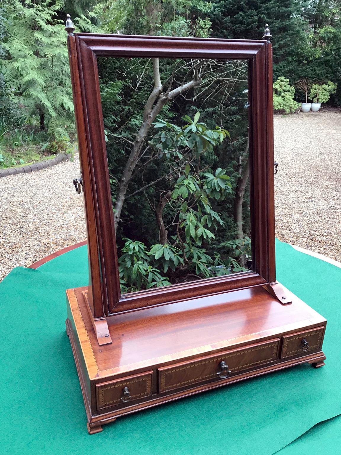 Georgian mahogany inlaid swing frame dressing mirror which is crossbanded with rosewood, fitted with three drawers and brass fittings, on ogee bracket feet,

circa 1820.

Dimensions:
Height 20.5 inches – 52 cms
Width 15 inches – 38 cms
Depth