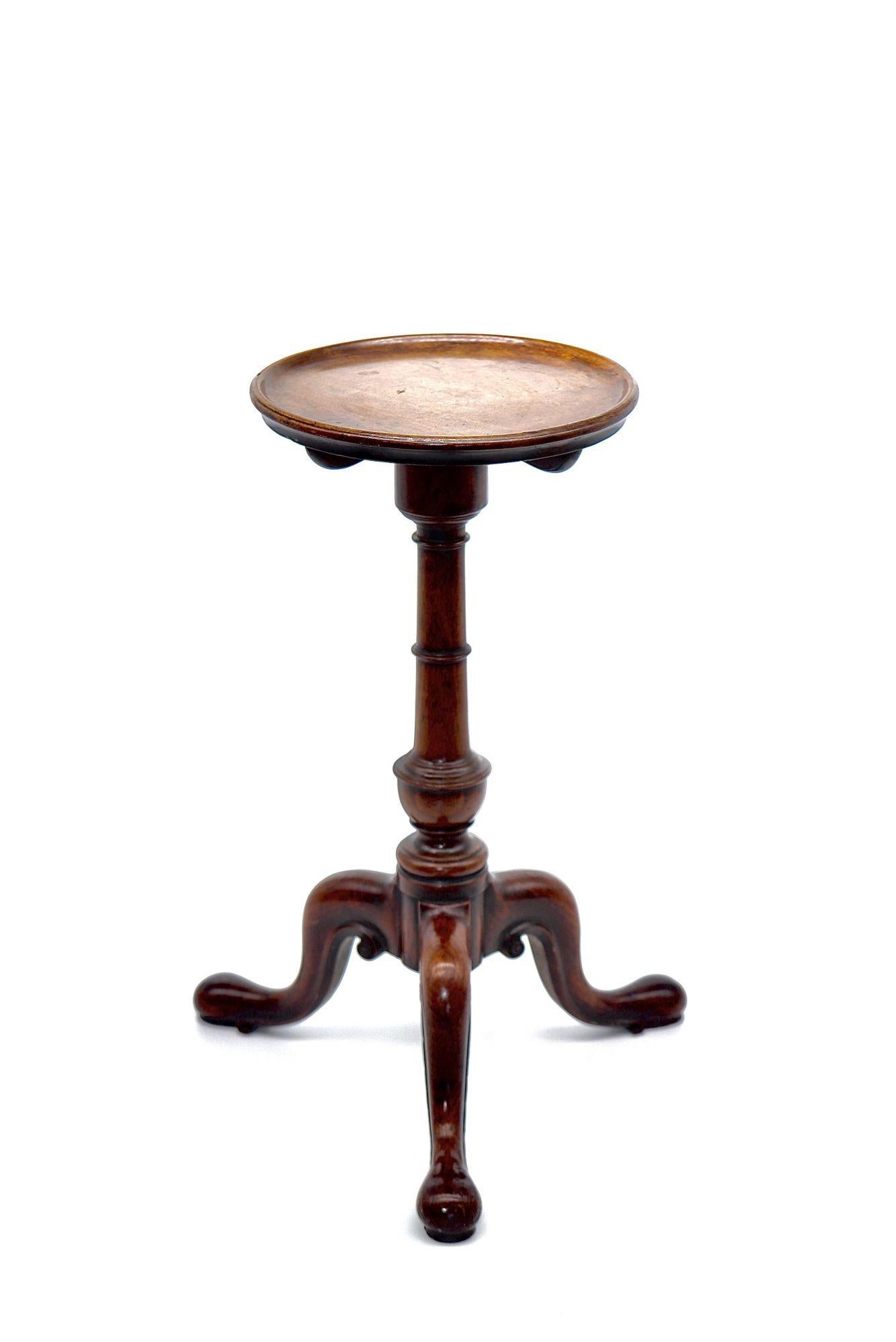 Irish well figured circular dish top raised on elegant turned stem and carved scrolling tripod legs. The Kettle stand table is small circular or square table for holding a teakettle or hot-water urn. We like to use them as drink tables.