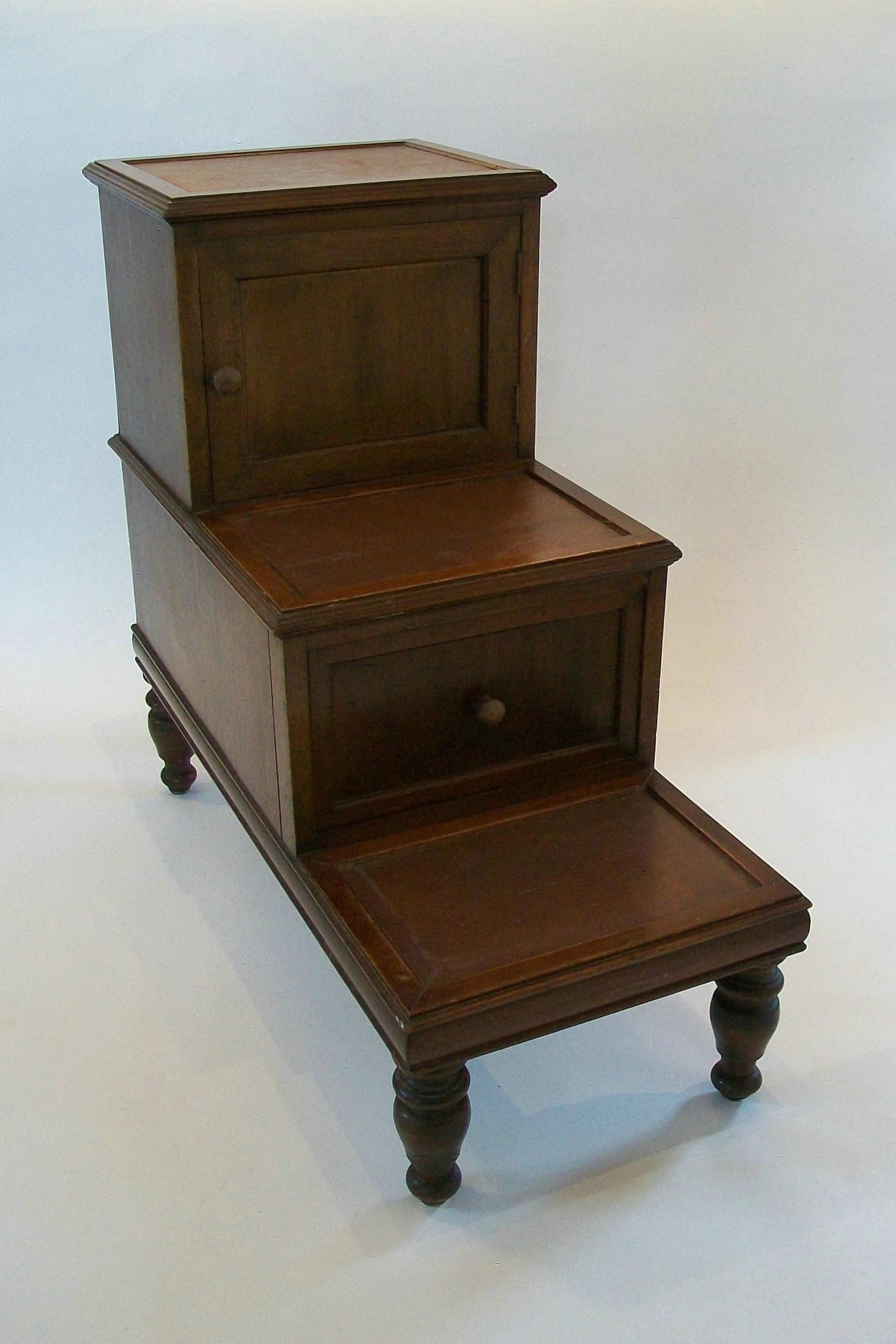 Fine Georgian (Regency Era) hardwood and leather library steps (doubles as an end table) - exceptional bench made quality with warm aged patina - featuring a solid wood frame with one cupboard and one drawer within the steps - finished with the