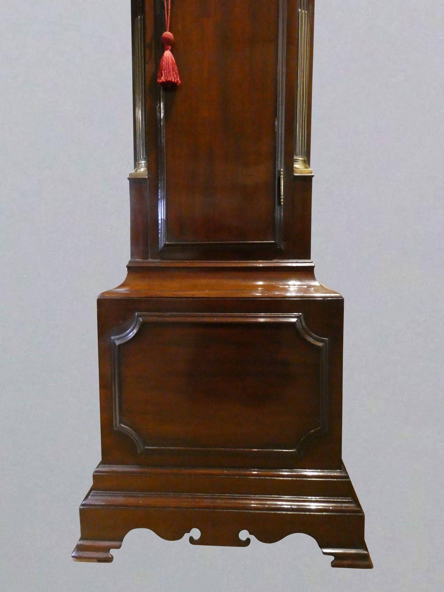 Georgian longcase clock by John Ross, London
 
Finely figured flame mahogany case with stepped base, raised moulding to the plinth, long break arch top trunk door with brass escutcheon, canted corners inset with brass. Break arch hood with brass