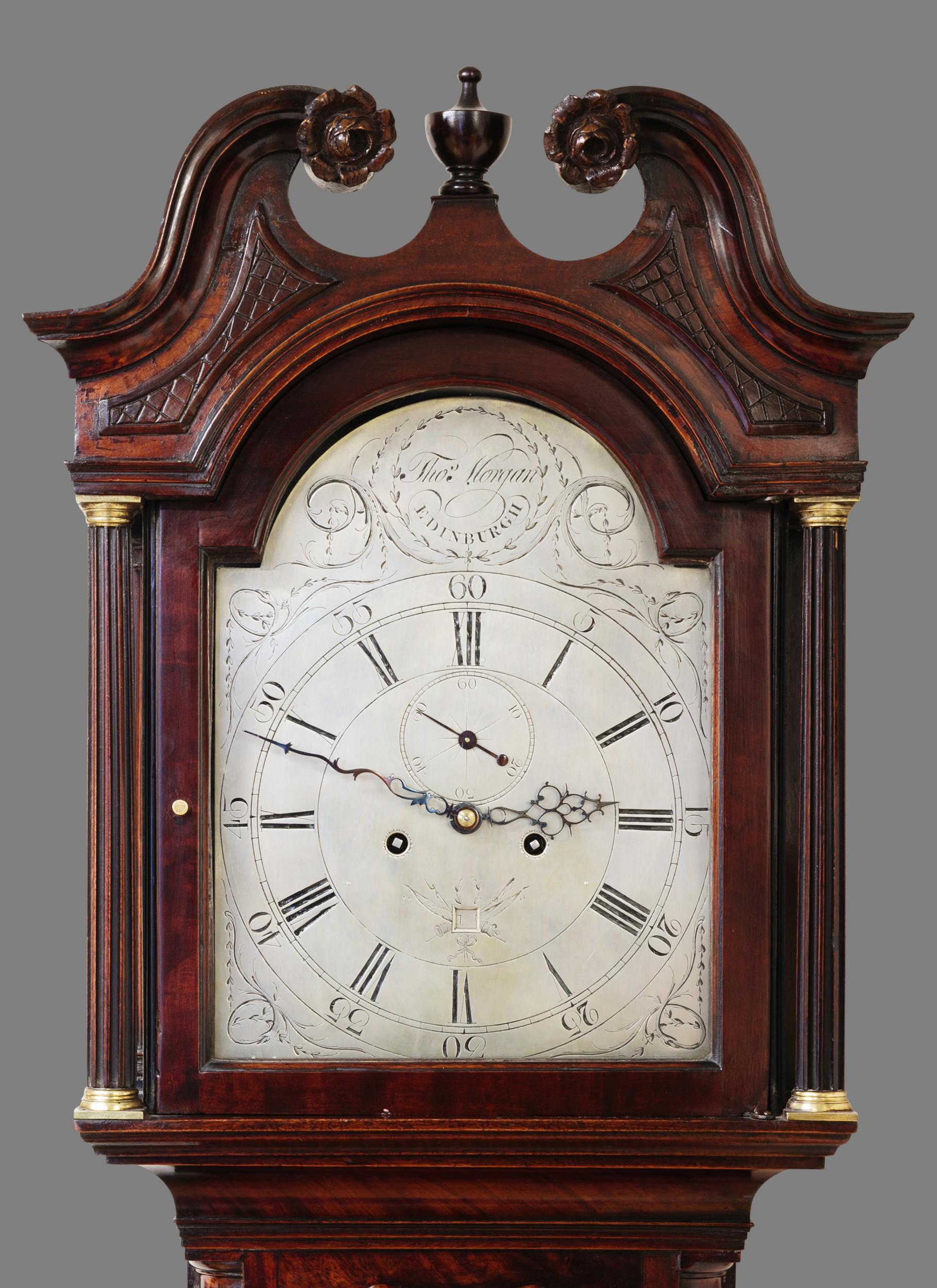 Mahogany longcase by Thomas Morgan, Edinburgh

Fine mahogany case standing on bracket feet with canted reeded corners. Long break arch trunk door, swan neck pediment, reeded pillars with brass capitals to either side of the hood door.

Silvered