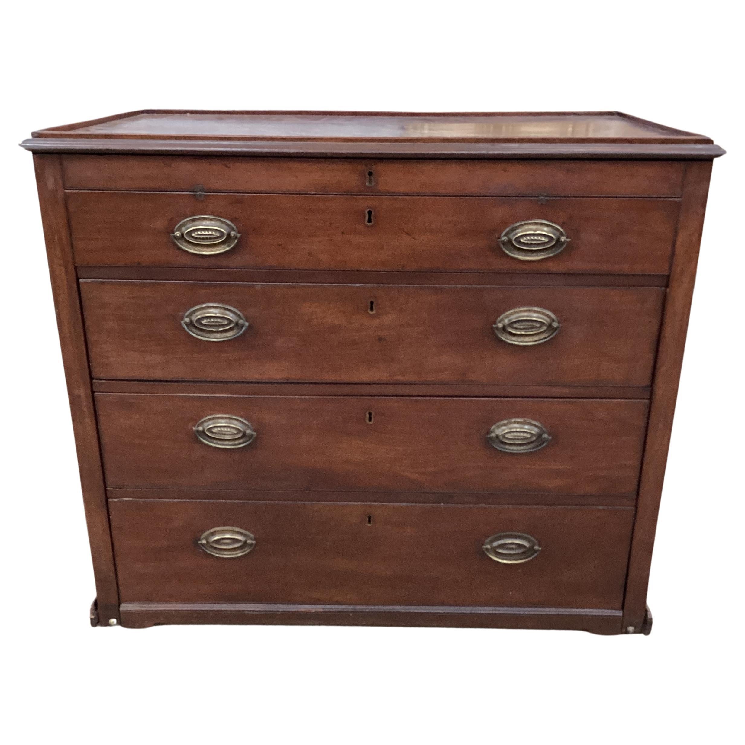 A rare English Georgian Mahogany Metamorphic Chest with a slide out drawer that reveals a drafting slope. Chest has the original cast iron handles.. The chest is constructed from beautiful single board Cuban mahogany and retains a lovely aged