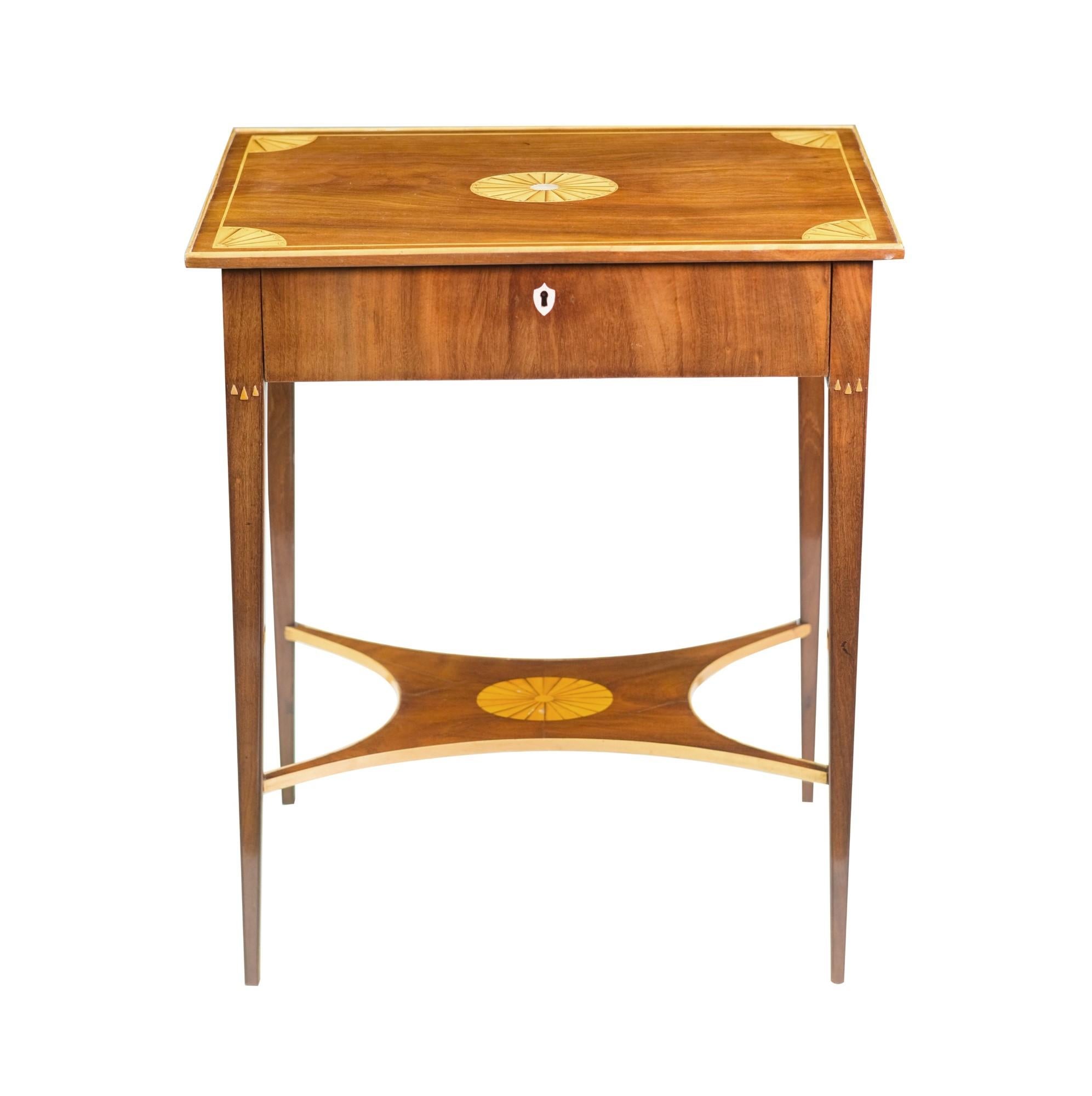 Antique Georgian style table made of a combination of mahogany and birch wood. It has a mother-of-pearl inlay on top and the drawer has 8 small compartments and 3 small drawers. The Key for the drawer is also included. This can be seen at our 400