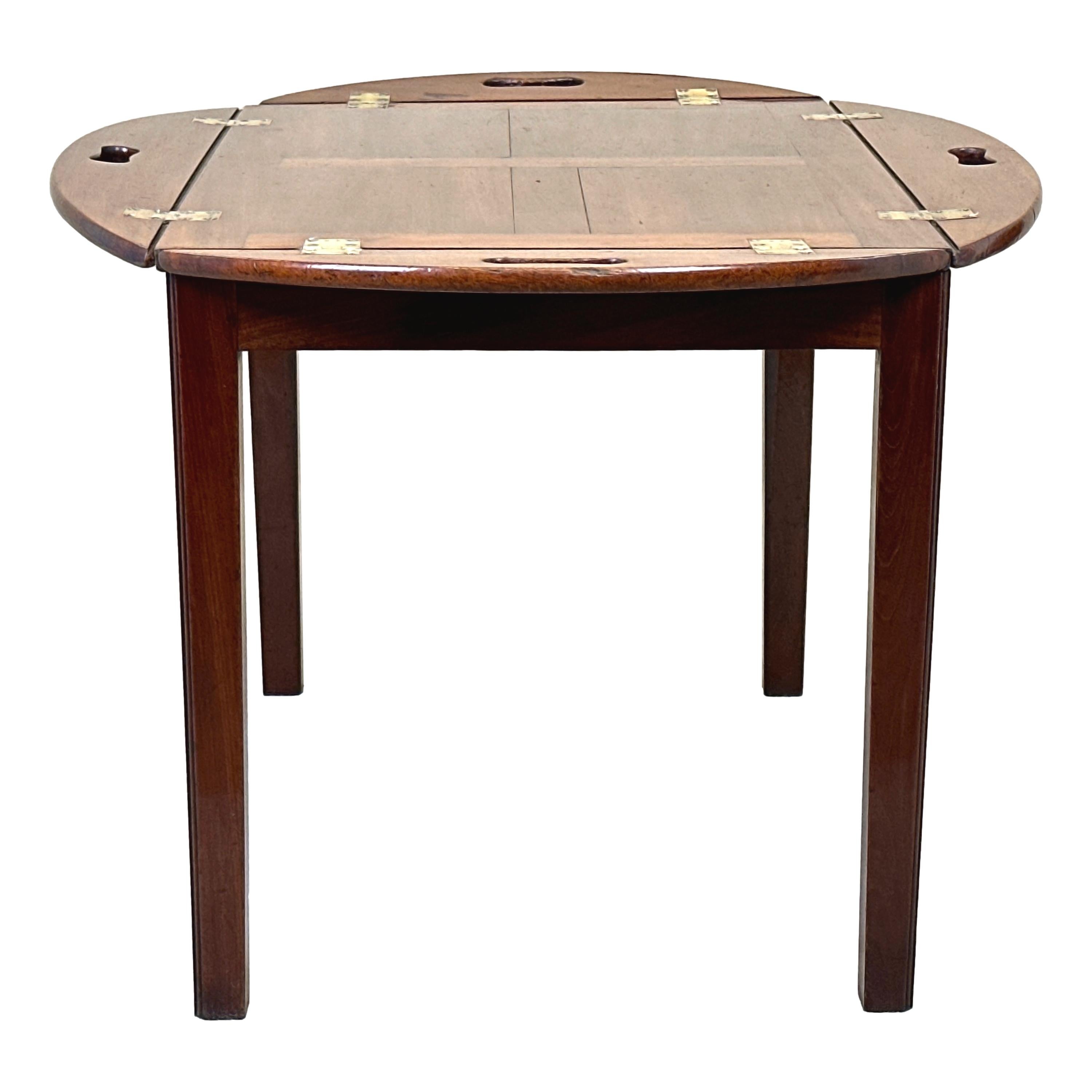 A very good quality late 18th century, Georgian period, mahogany oval butlers tray of Panelled design, retaining original brass hinges to folding sides with pierced carrying handles, raised on later square leg mahogany stand.


During the 18th