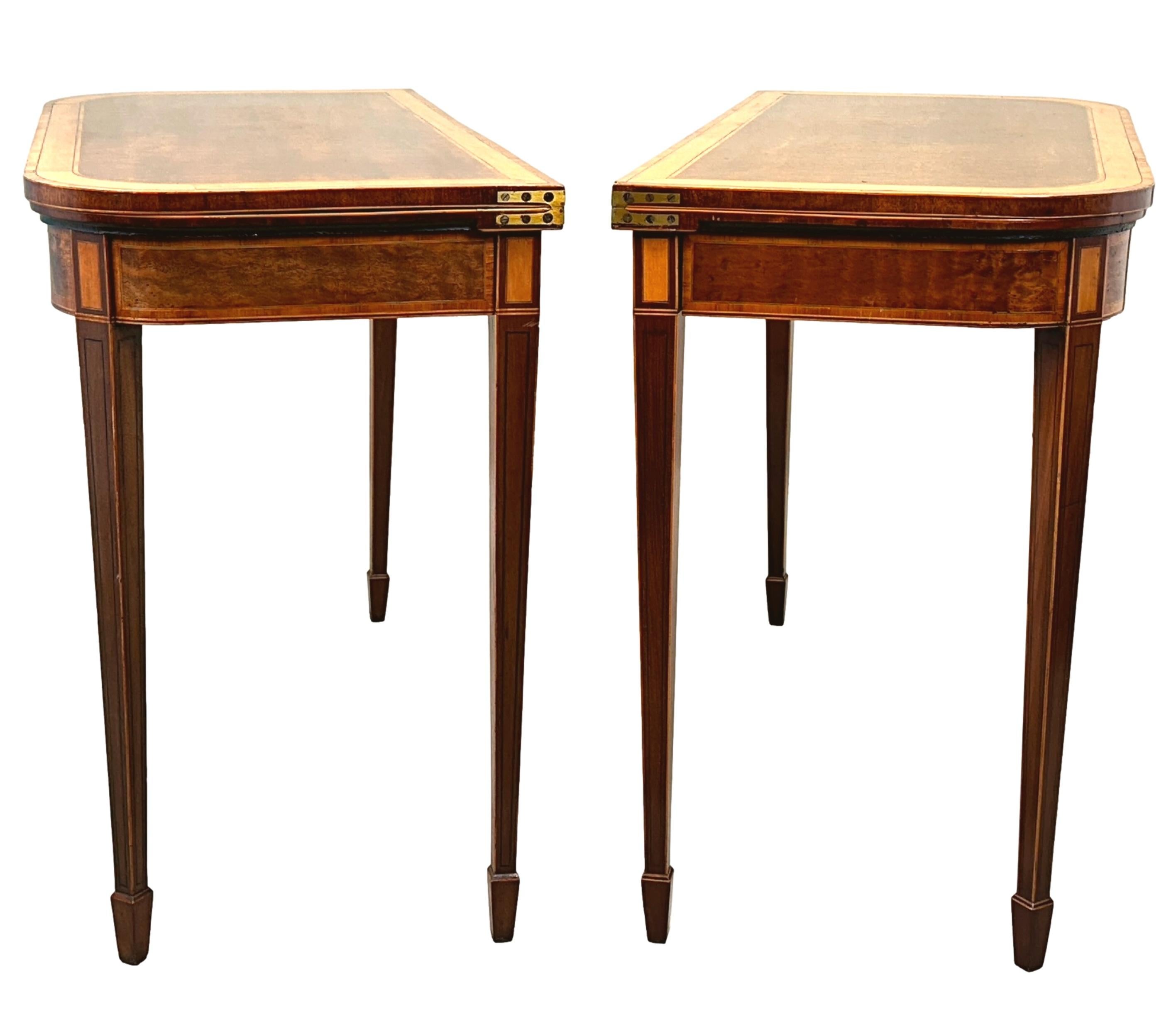 A Very Fine Pair Of Late 18th Century, Georgian, Sheraton Period Mahogany Card Tables, Of D Shaped Form, Having Superbly Figured Foldover Tops With Crossbanded Satinwood Decoration And Enclosed Baized Playing Surface To Interiors, Over Freize With