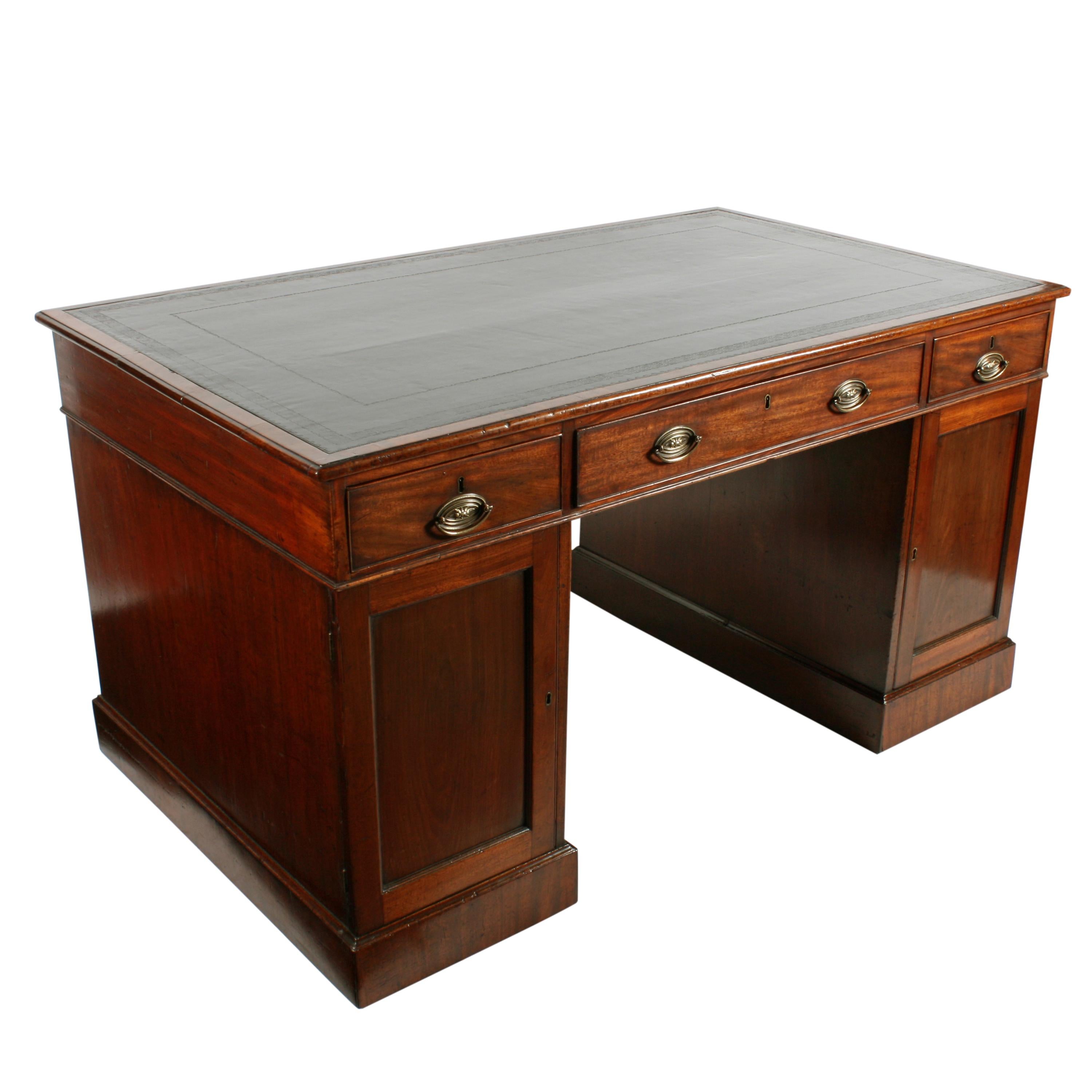 A Georgian mahogany partner's desk.

The desk has twelve drawers, two cupboards and a tooled black leather top.

The desk has nine oak lined drawers to one side and three drawers and two cupboards to the other side.

The drawers have a cock