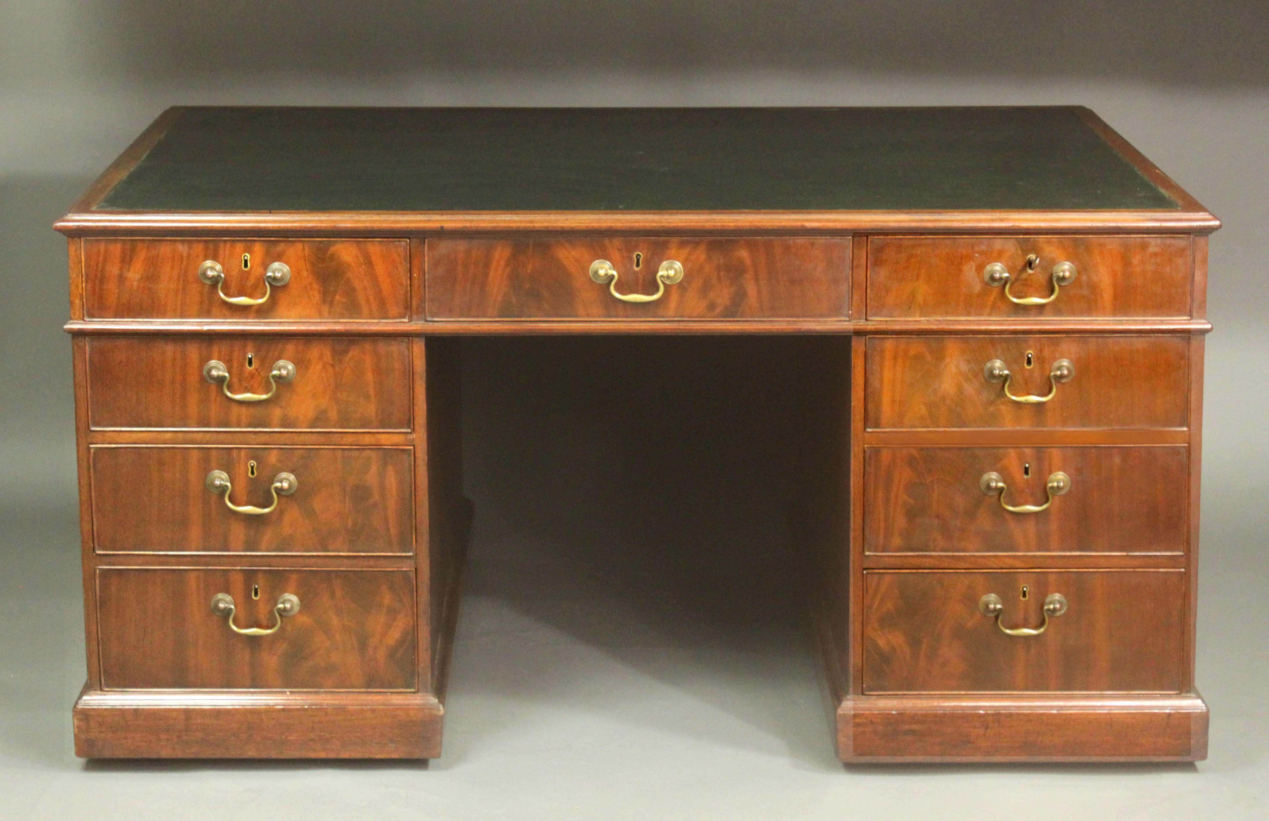 A rare George III partners desk of a good nut-brown colour and patina, drawers on the front and back (no cupboards), the cock-beaded drawer fronts attractively veneered in one continous sheet of figured mahogany, cedar lined drawers and many of the