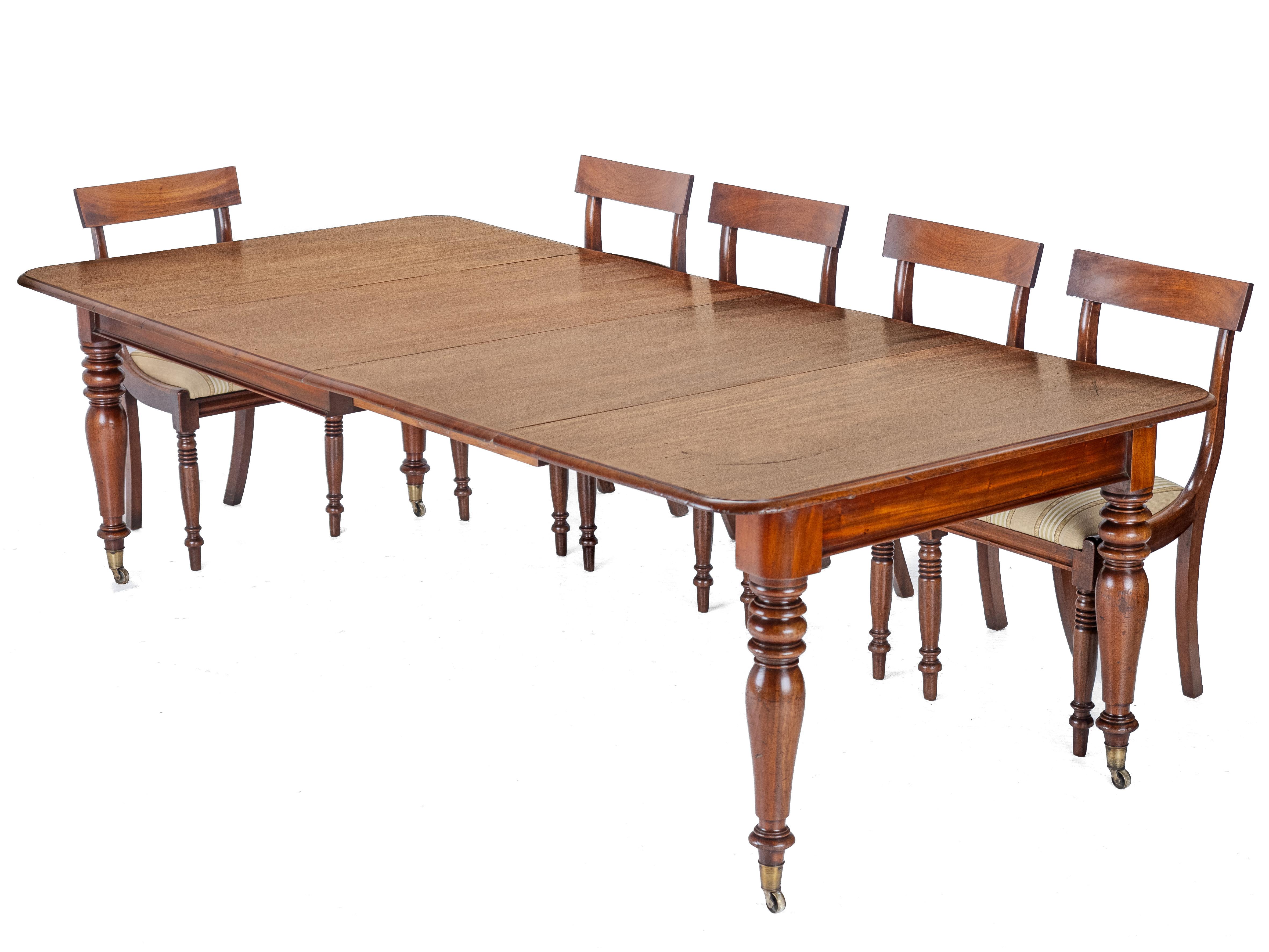 A late Georgian, second quarter 19th century, mahogany extending dining table, from the George IV period. This large extending dining table features a solid mahogany top with rounded corners and moulded edge. The table extends by way of telescopic