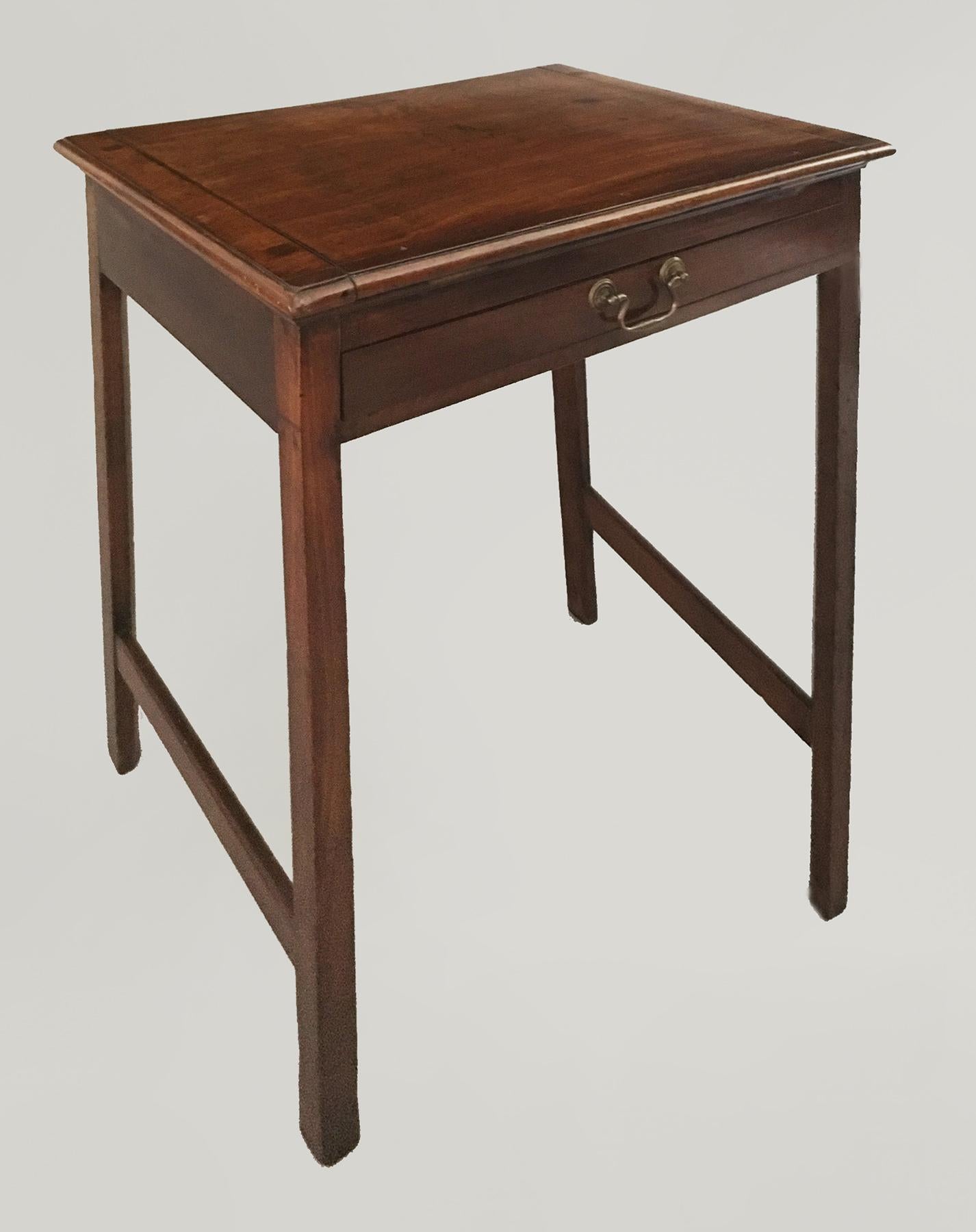 George III mahogany reading or writing table with an adjustable reading slope and a removable ledge, one drawer with a brass swan neck handle, raised on straight legs with H-shaped stretchers.