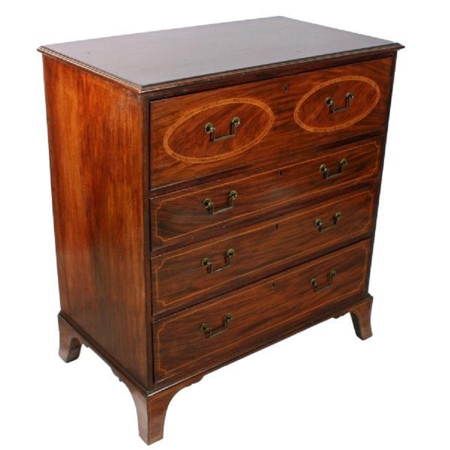 A neat size early 19th century Georgian mahogany secretaire chest of drawers.


The top secretaire drawer is decorated with two oval panels cross banded in kingwood and box wood line inlay.


The interior is fitted out with six drawers, eight