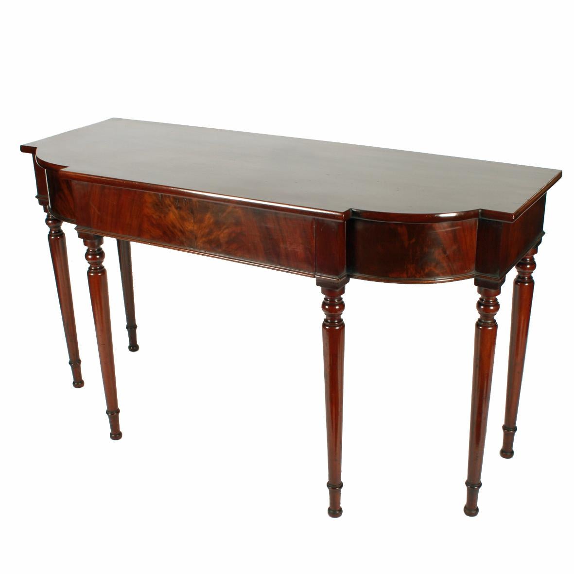Georgian Mahogany serving table.


A Georgian mahogany side or serving table.

The table stands on six turned legs and has a shaped one-piece top.

The table has a large concealed central drawer with a hand grip underneath and is oak and pine