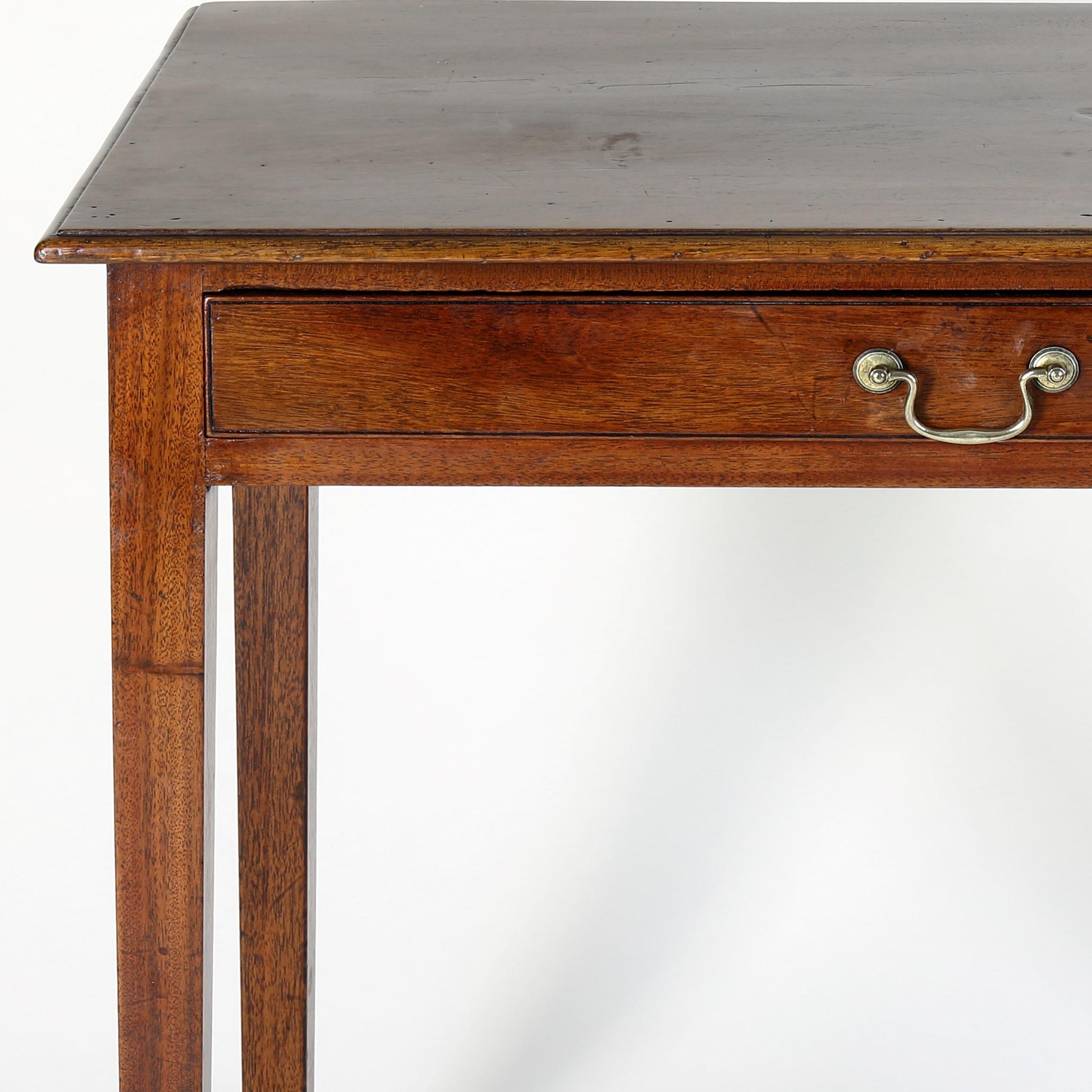 A good late 18th century mahogany single drawer side table with rectangular moulded edge top above a long apron drawer and standing on four square tapering legs.
In original condition including the central brass swan-neck handle. a simple yet
