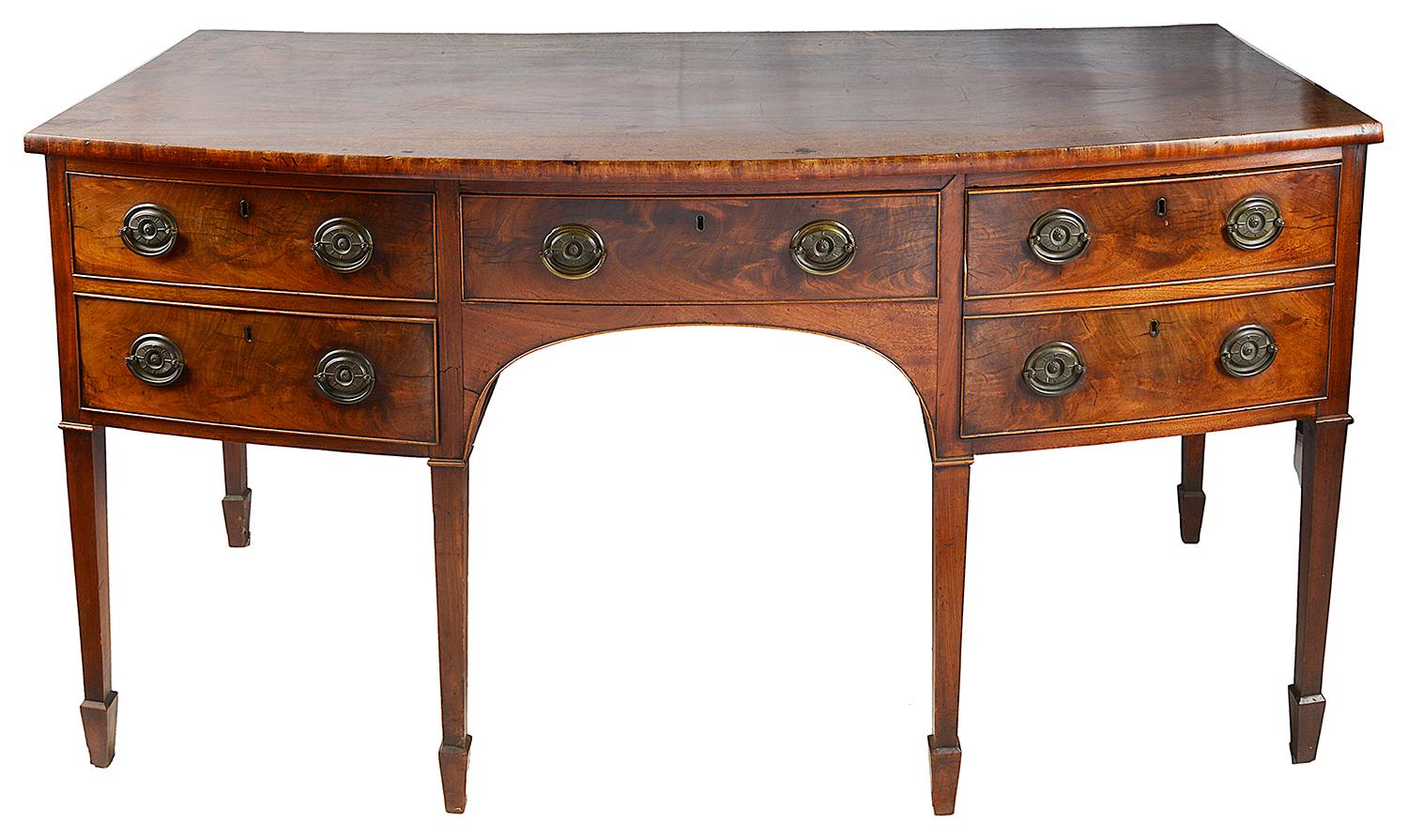 A good quality 19th century Georgian period Mahogany bow fronted sideboard, Having four drawers with brass ring drop handles, one being a double cellaret drawer, raised on square tapering legs, terminating in spade feet.