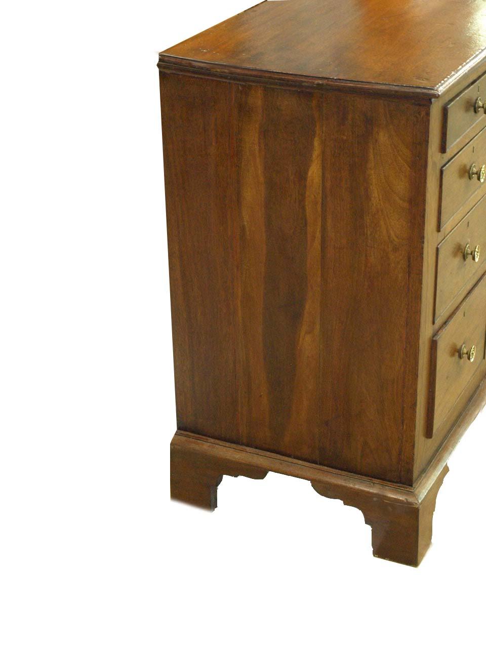 Georgian mahogany sideboard with nine drawers surrounding center recessed door, interior with one shelf. Brass knobs are typical for this piece but are not original. Of note, the top has been professionally refinished and has a slightly darker umber