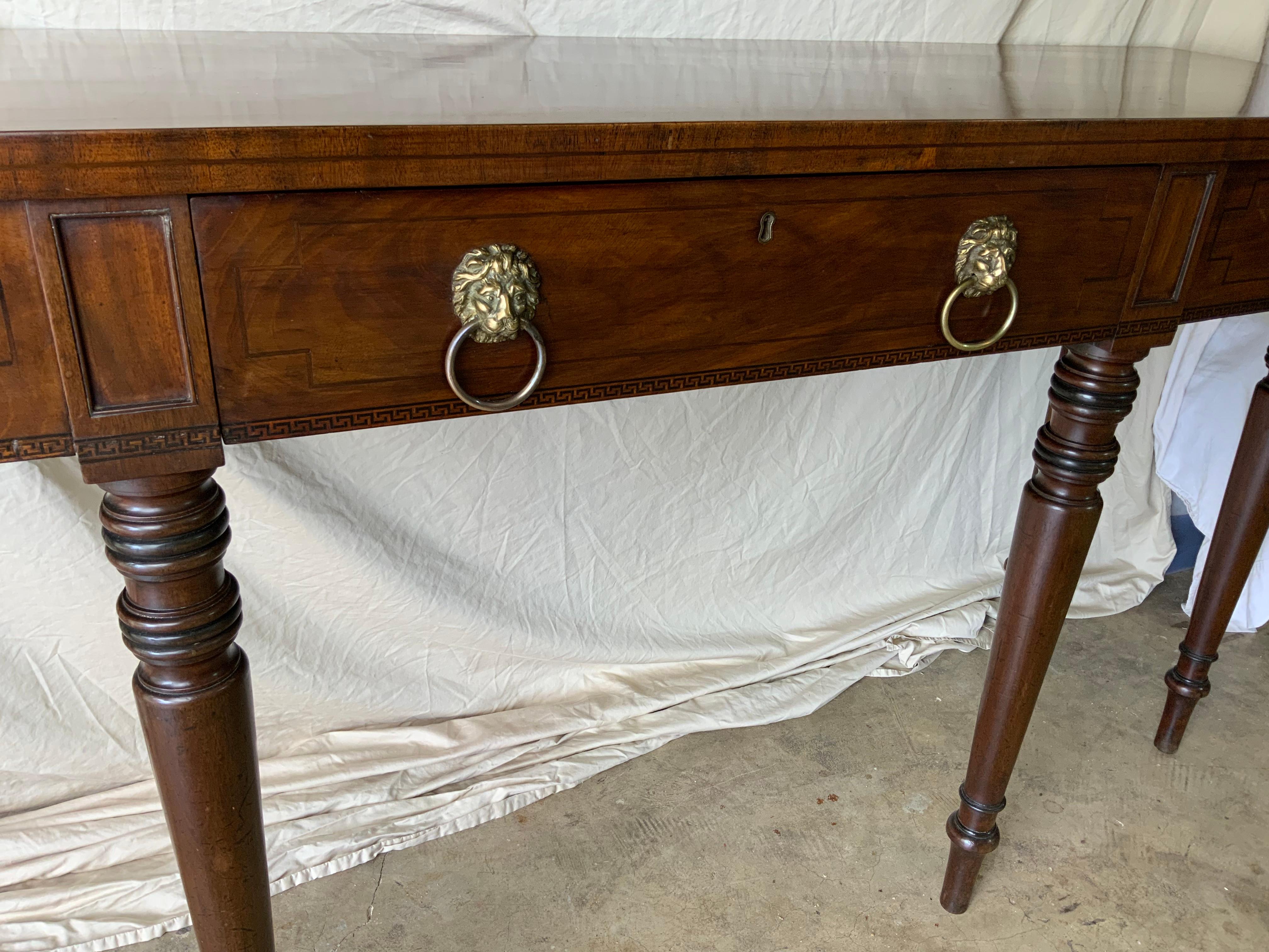 A very nice early 19th century Sheraton Mahogany Sideboard / Server 1830-40. Very nice color and aged patina on the original surface. One large solid Mahogany board top over a figured Mahogany drawer frieze with a Greek key inlay resting on six