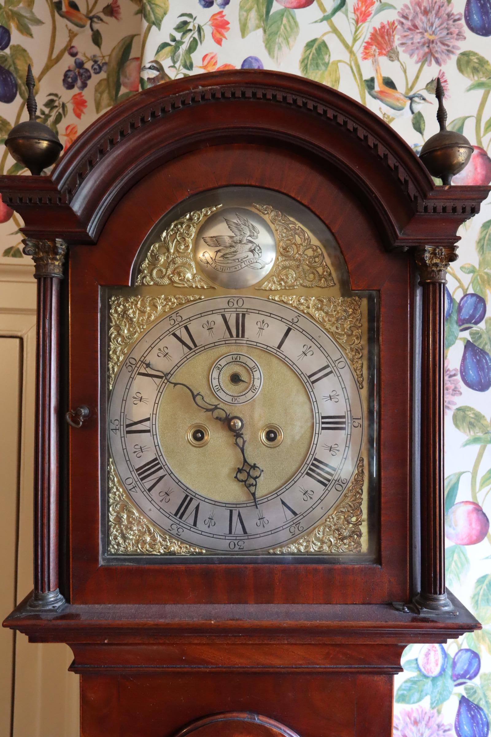 Step into the elegance of the Georgian era with this exquisite mahogany striking longcase clock, a remarkable embodiment of the craftsmanship and style of George III's reign. The warm hues of the mahogany case exude a sense of timeless