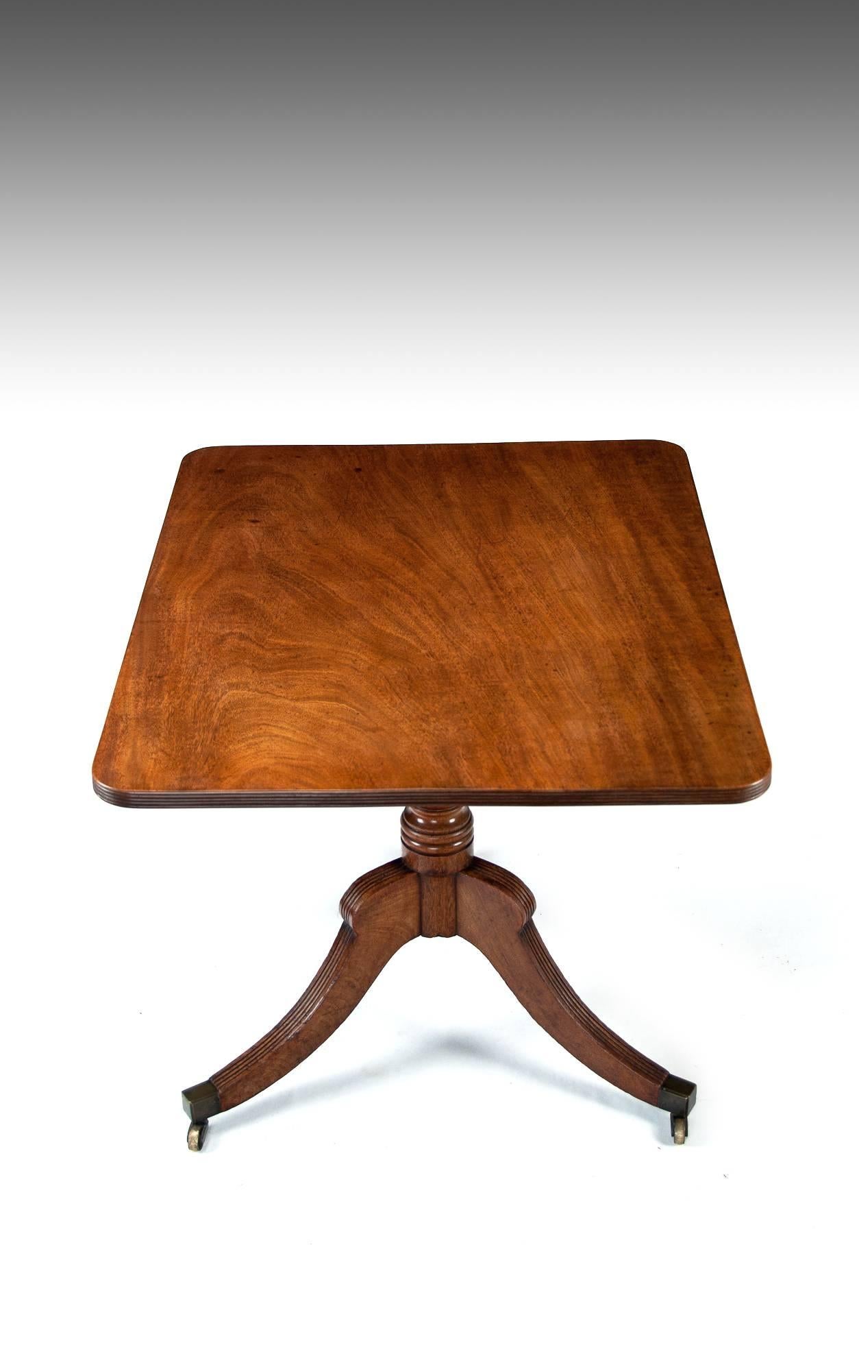 A Georgian mahogany tilt-top table of good color circa 1800
This table of small proportions has a good quality solid mahogany reeded edge tilt top of excellent color. Standing on ring turned columns and splay reeded legs terminating on brass box