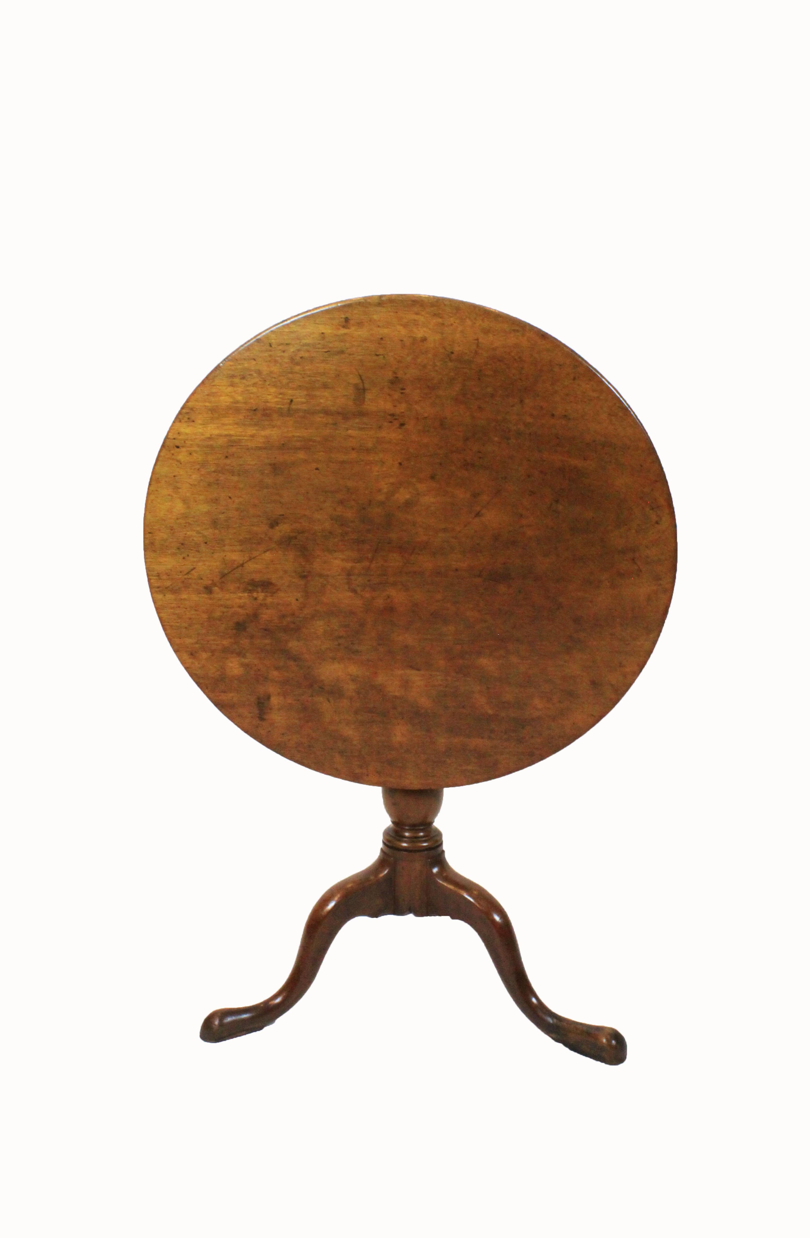 George III mahogany tilt top table with turned column and cabriole legs. Top is made from a single board with rounded edge.