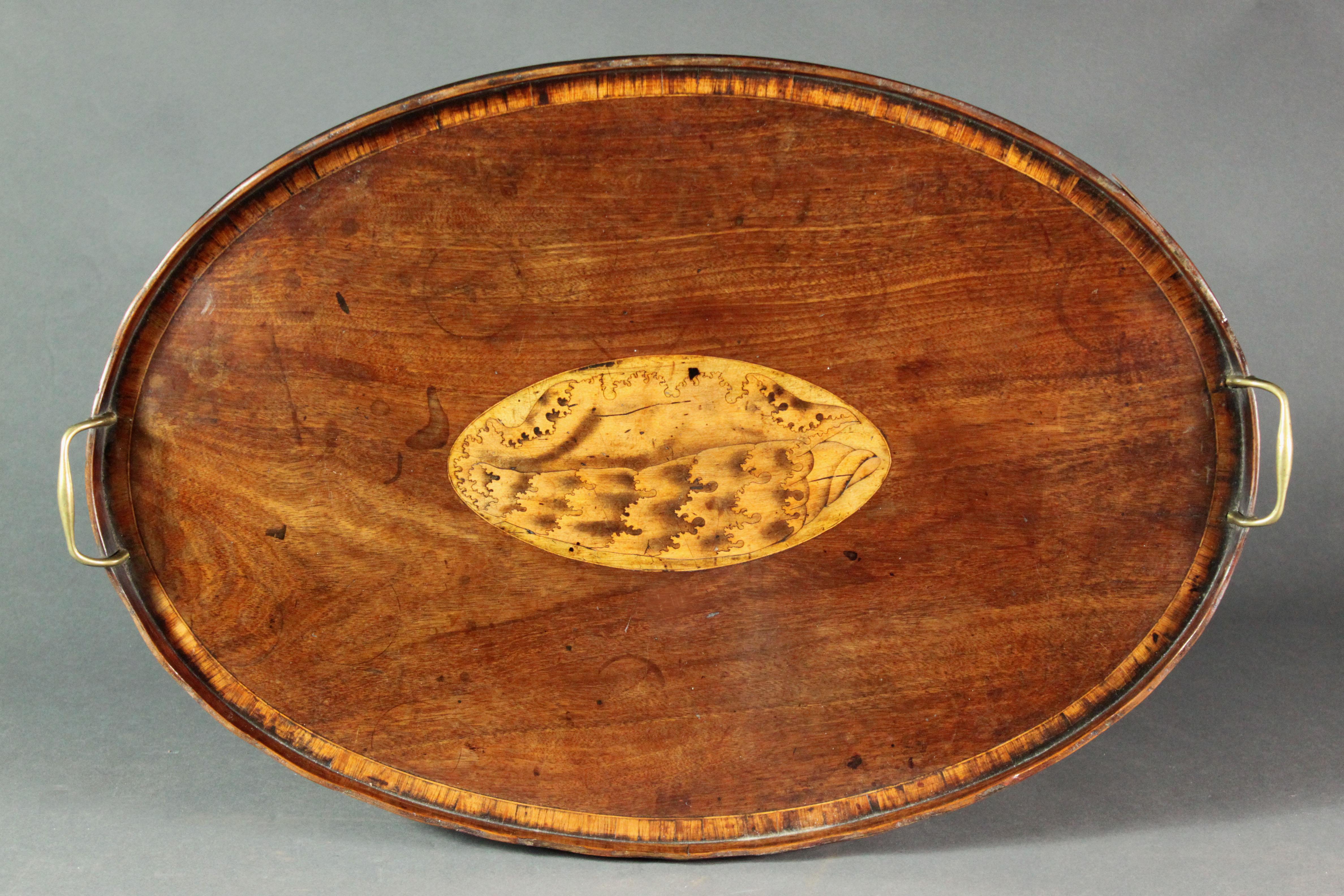 A fine George II Sheraton period oval try in figured mahogany of a good colour and patina with kingwood cross-banding, attractive shell inlay to centre, original brass handles. Note the laminated gallery ~ Georgian trays usually have this feature.