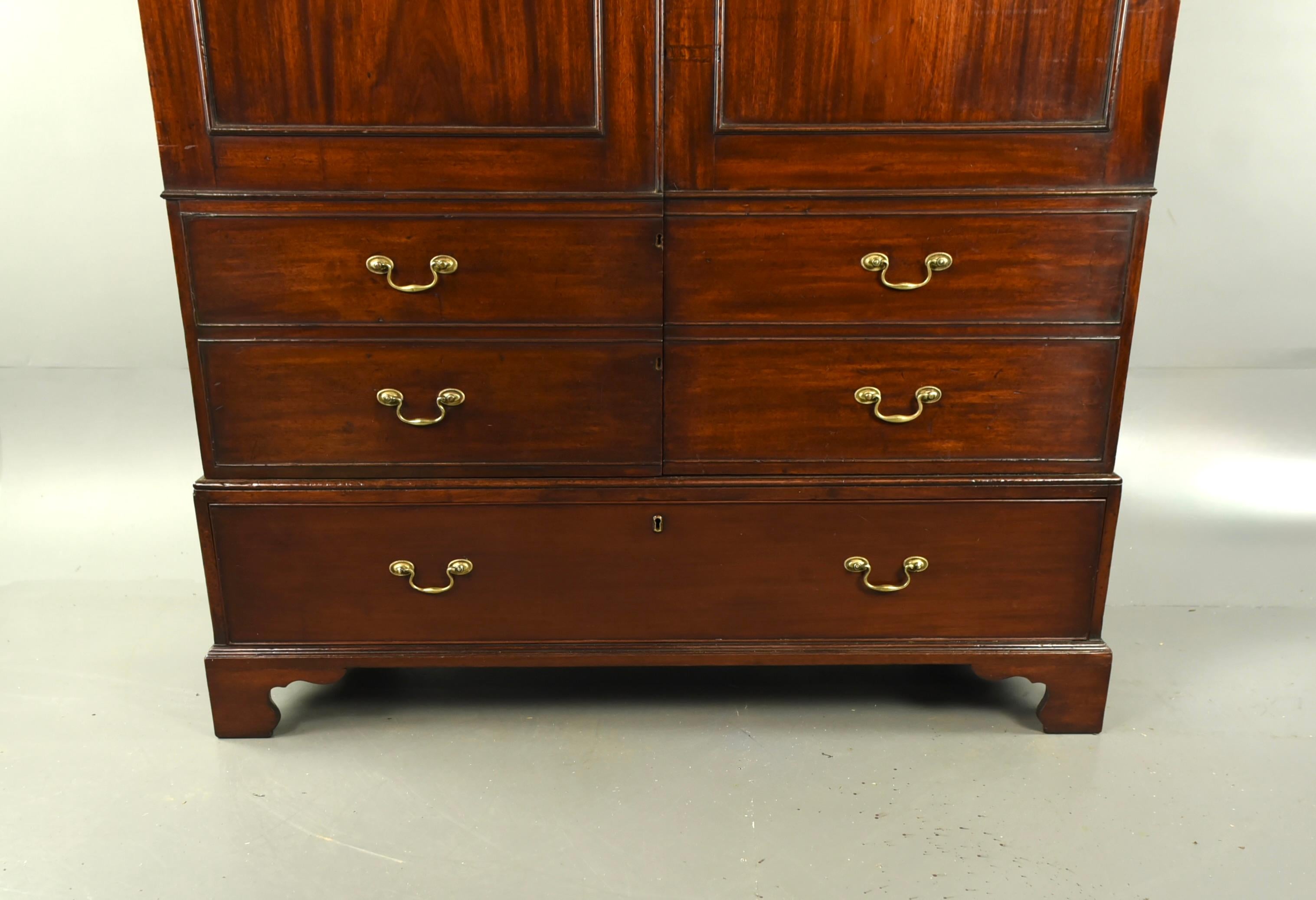 Fine Quality Georgian mahogany double wardrobe circa 1810 .
The wardrobe has two solid mahogany panelled doors with two blind drawers and a large drawer to the base . It has a fantastic colour and grain and have been professionally cleaned and waxed