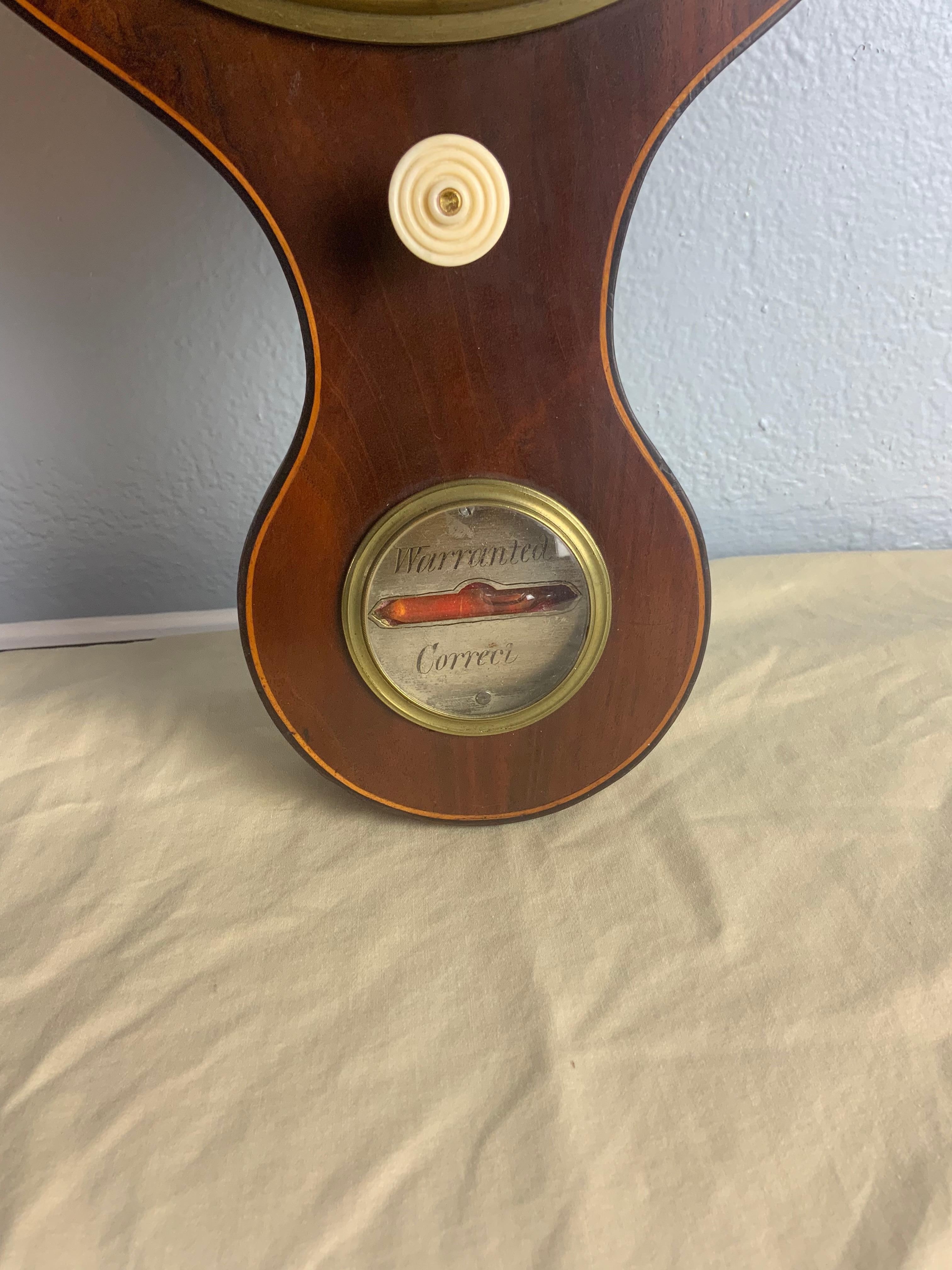 A very nice Mid-19th Century mahogany georgian wheel barometer with decorative Ebony and Holly string inlay around the outer edges of the case. Sold as is because some of the small internal pieces are missing for the Mercury tubes. The case is in