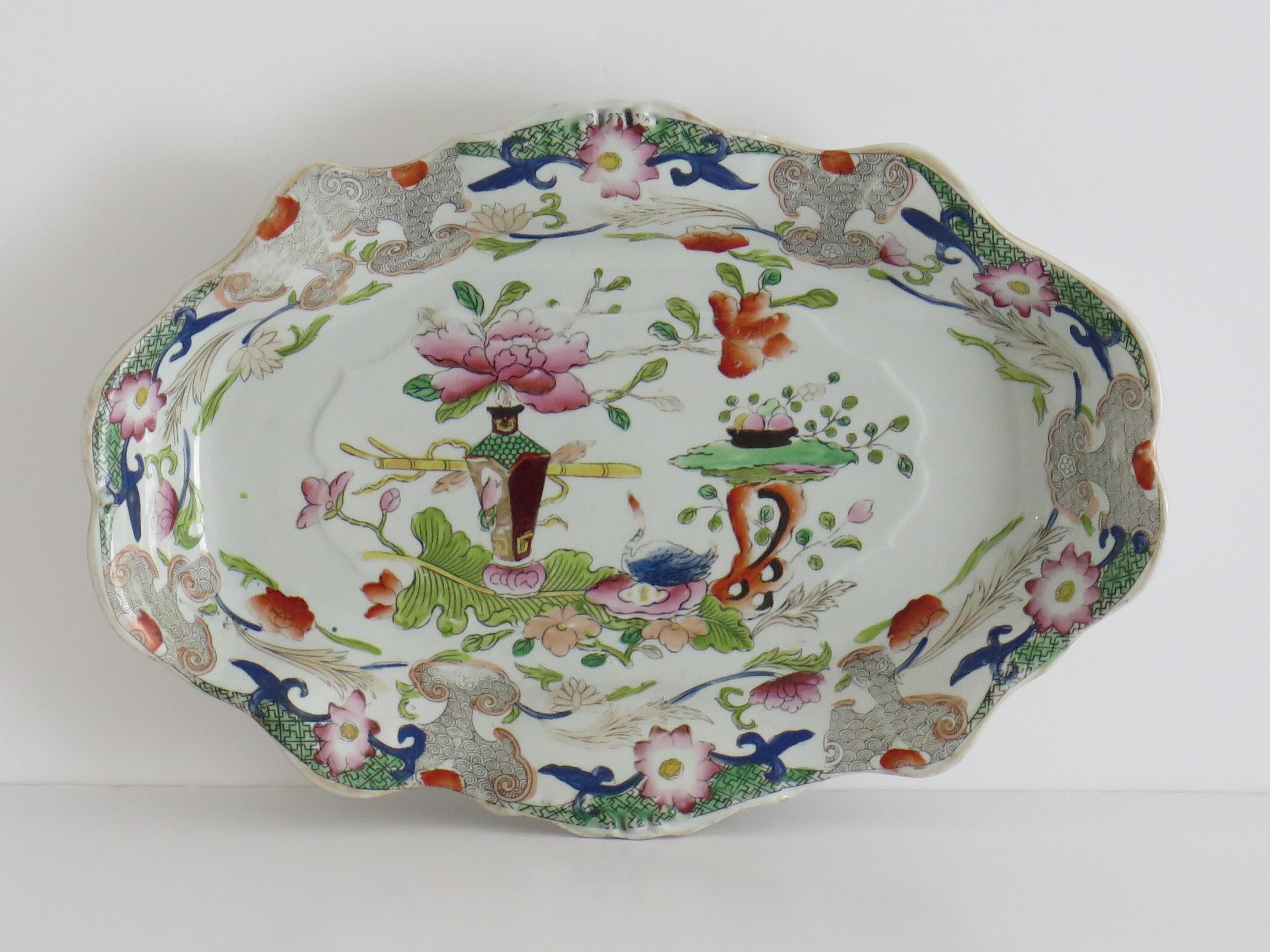 This is a very good hand painted Mason's ironstone large Desert Dish, in the table and flowerpot gilded pattern, from their earliest George IIIrd period, circa 1818.

The piece is well potted with an oval shape having moulded wavy edges and standing