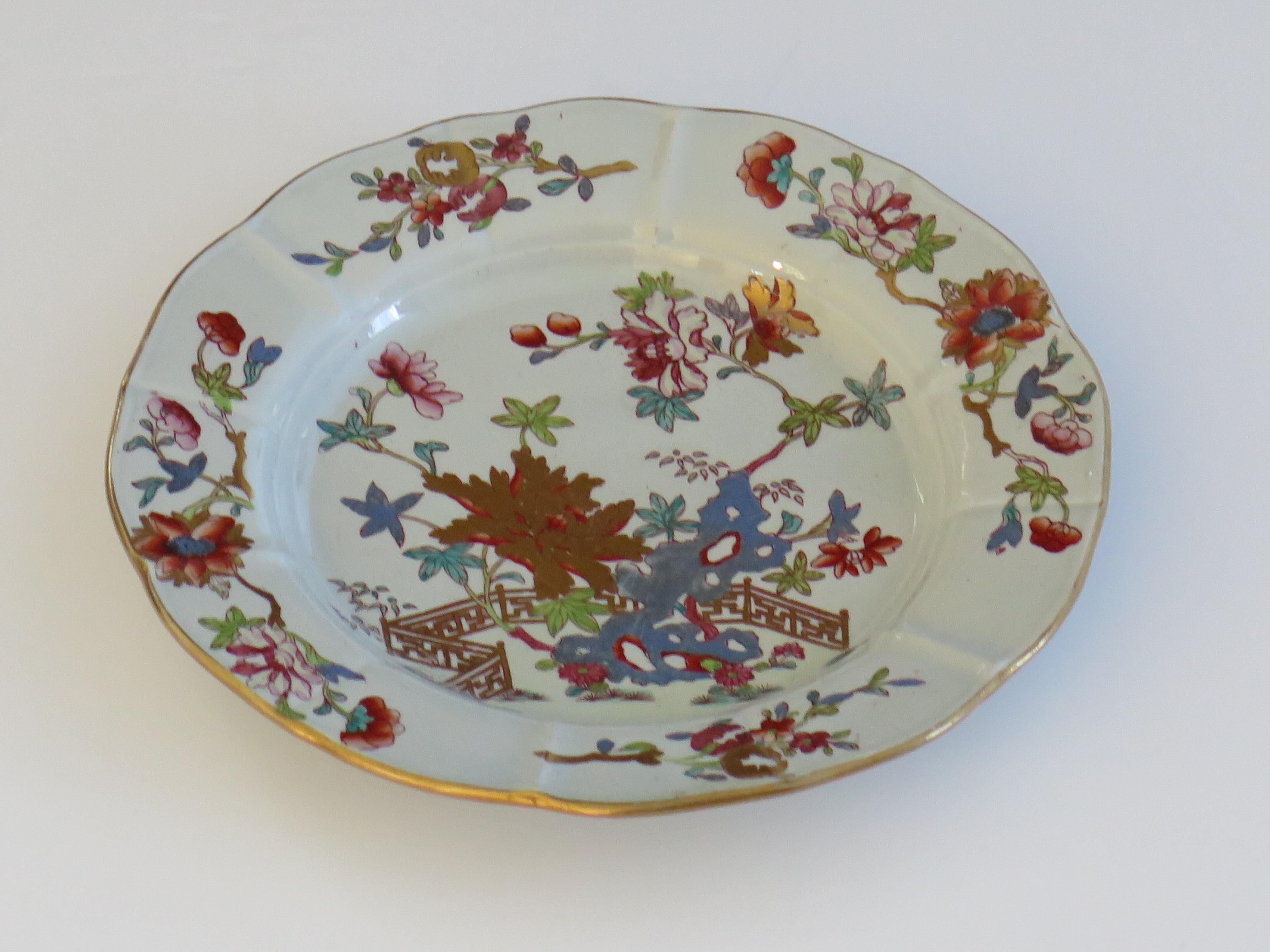 This is a very good hand painted Mason's ironstone Desert Plate, in the Fence, Rock and Tree gilded pattern, from their earliest George IIIrd period, circa 1818.

The piece is well potted with a circular shape having a wavy edge and ribbed radial