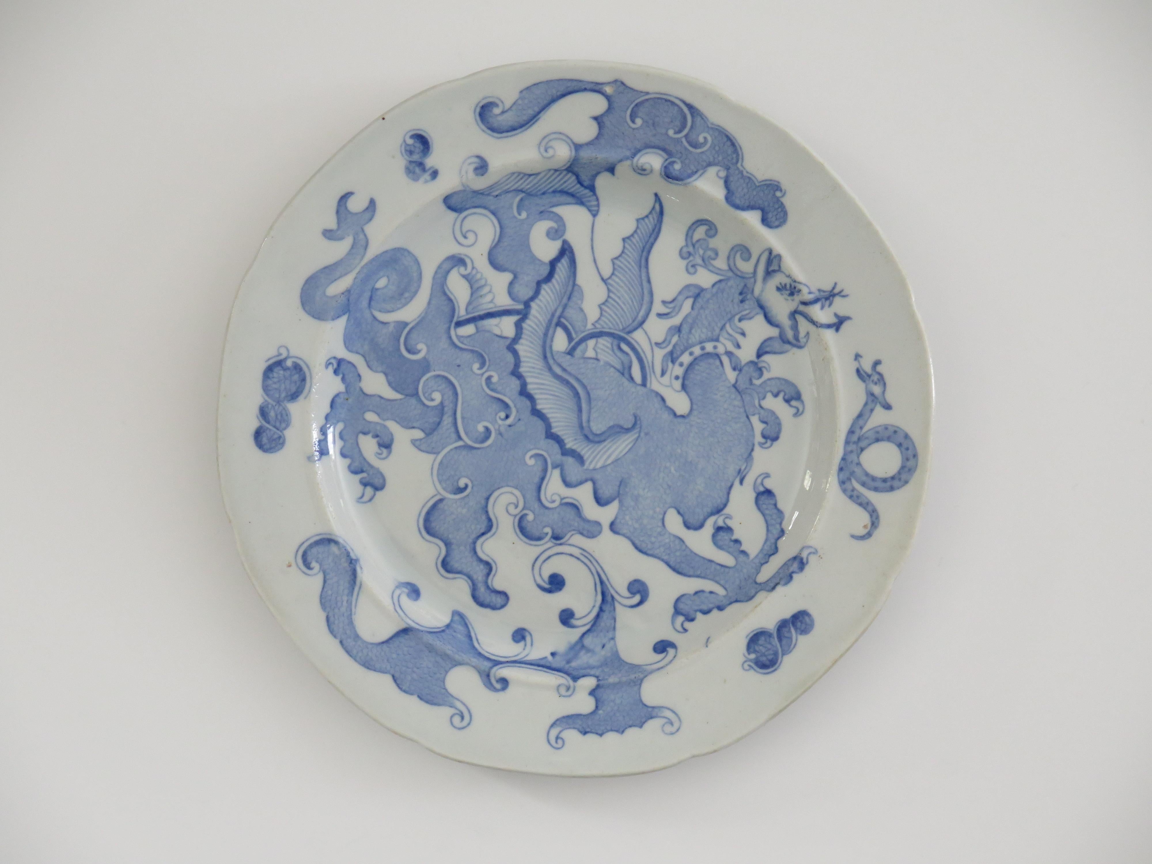 This is an early Mason's ironstone pottery Dinner Plate in the rare blue and white Chinese Dragon pattern, circa 1818.

The plate is circular with a notched indented rim.

This plate is decorated in one of the rare patterns called 