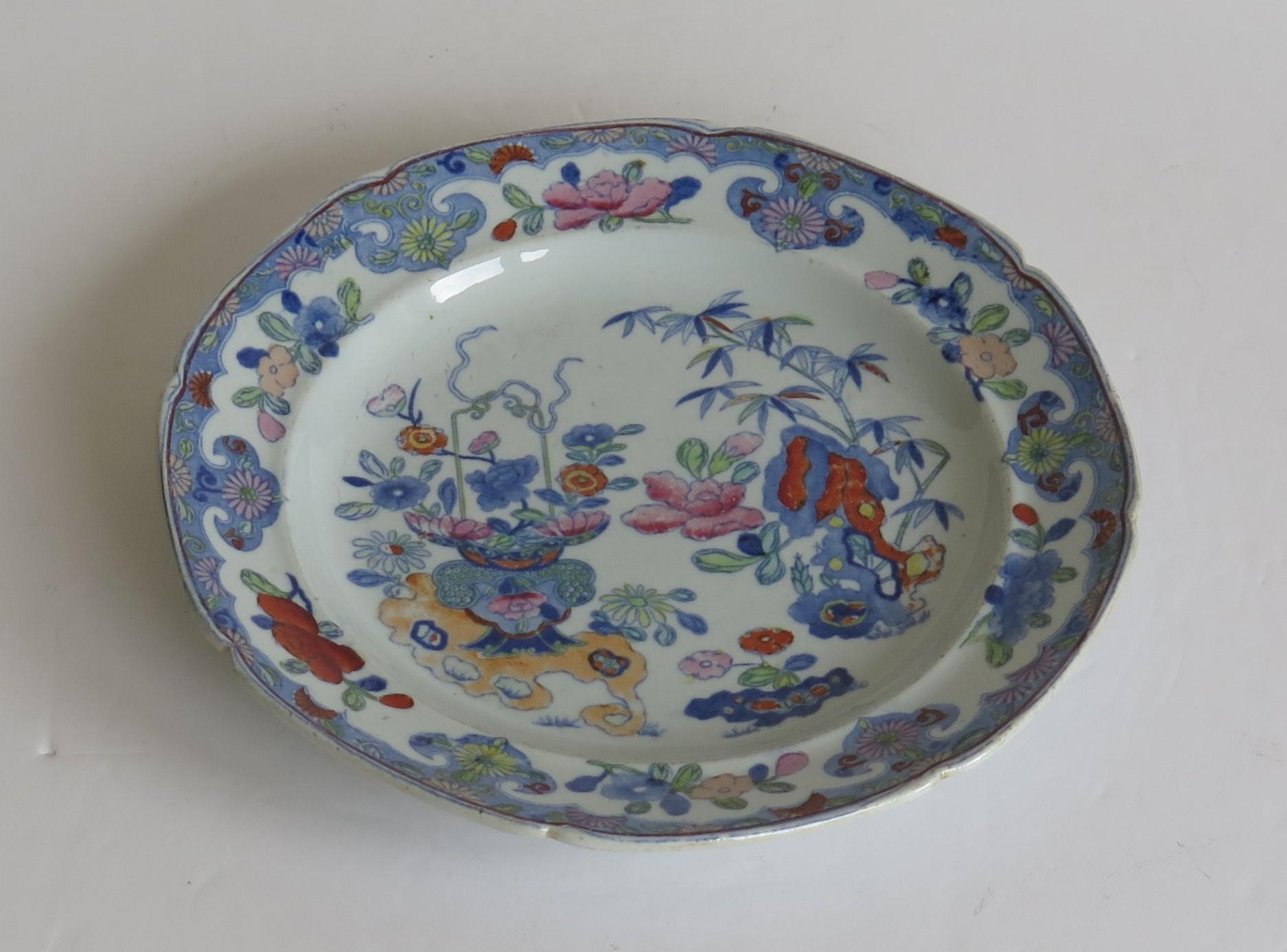 This is a very decorative dish or plate by Mason's Ironstone, Lane Delph, England in the Bamboo and Basket pattern, dating to the early 19th century, Georgian period, circa 1813-1820.

The plate or dish is fairly deep and circular in shape with a
