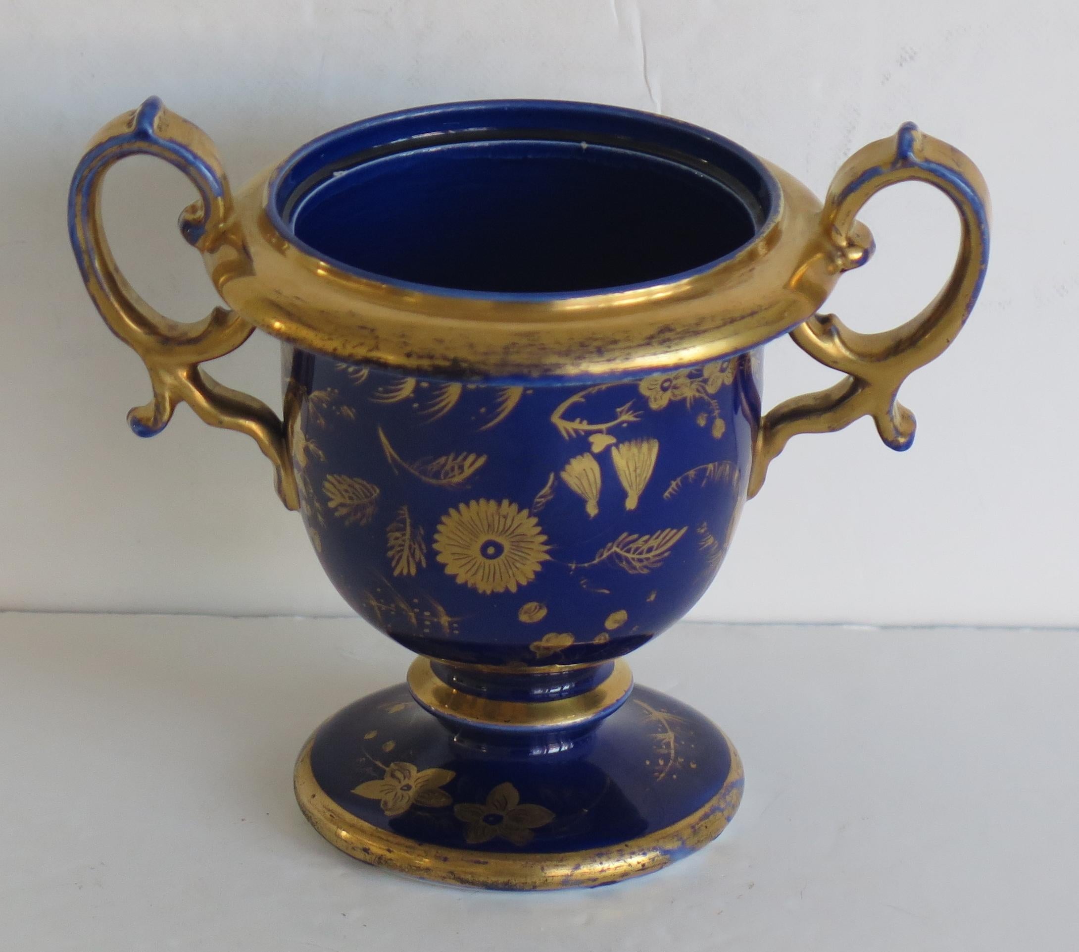 This is a rare ironstone vase with high loop handles, made by the Mason's factory, England in the early 19th century.

This footed vase is potted in a rare shape with two side handles, giving a very decorative profile.

 The vase is decorated in