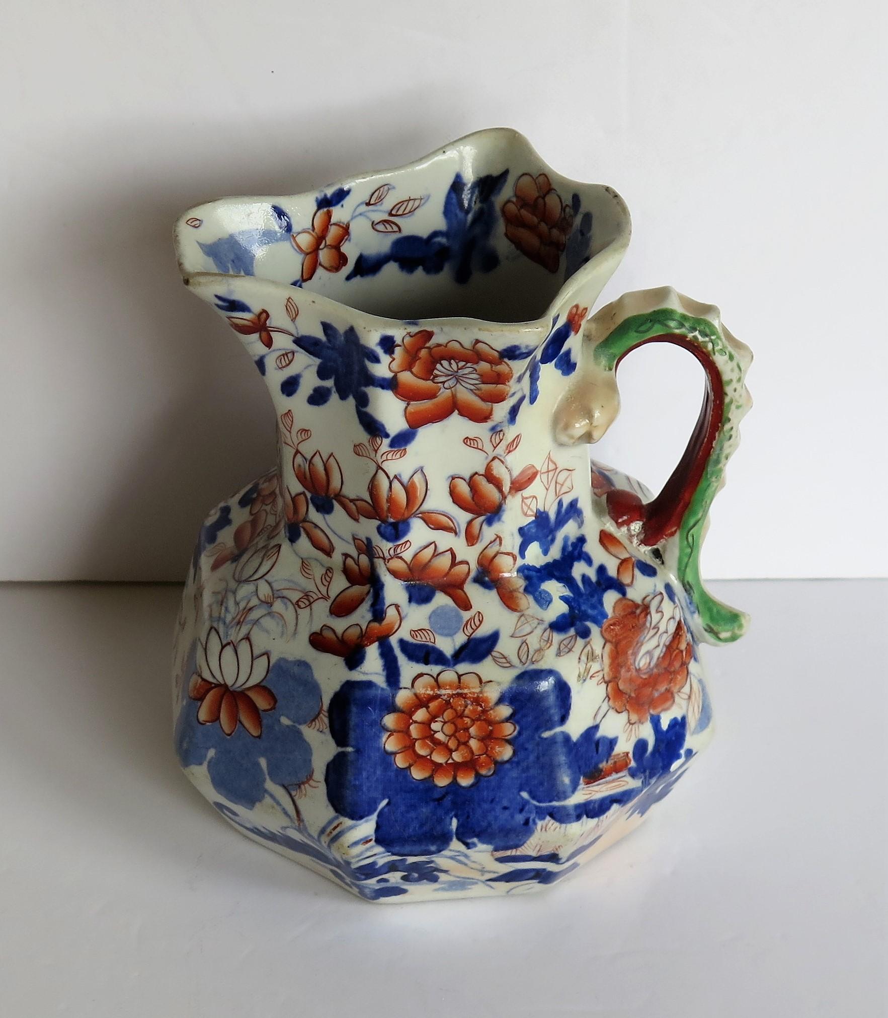 This is a good, early Mason's Ironstone Hydra jug or pitcher in the basket Japan pattern, made in the English, late Georgian period, circa 1820.

The jug has an octagonal shape with a notched snake handle and is decorated in the distinctive