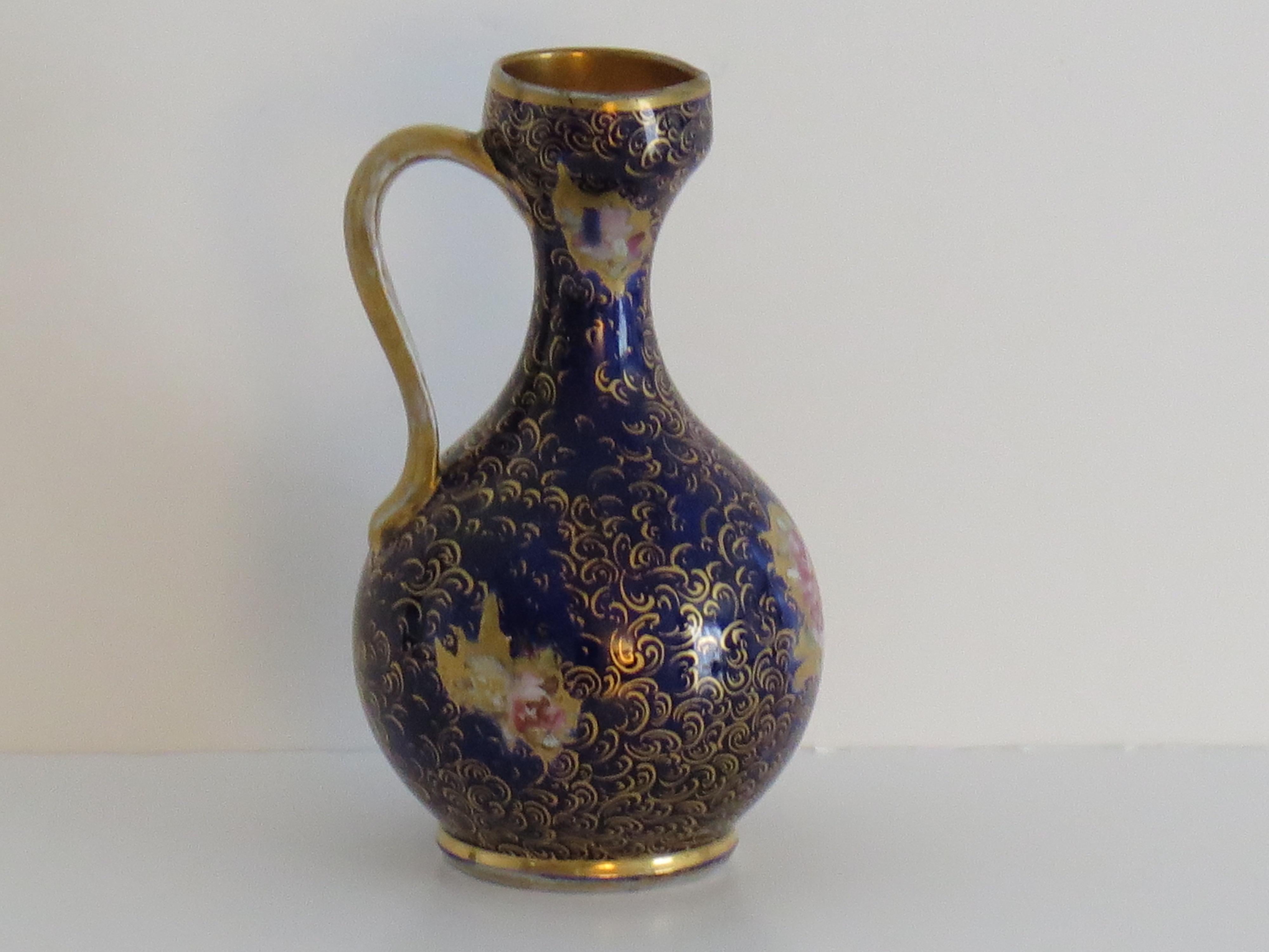 This is a very rare shaped early Jug or pitcher, hand painted in the gold gilded Rose Posies pattern against a Mazarine blue ground, made by Mason's Ironstone, Lane Delph, England and dating to circa 1813-1820.

This jug is hand potted in a very